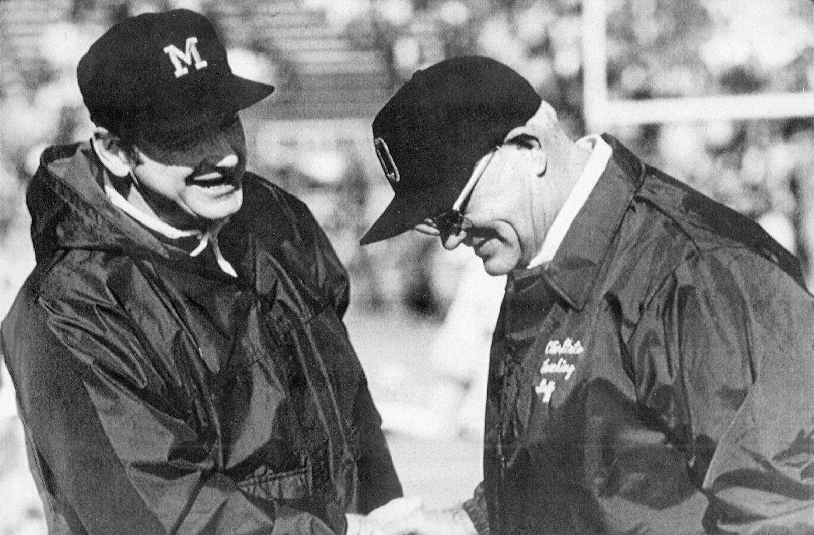 Michigan football coach Bo Schembechler, left, meets with Ohio State coach Woody Hayes in this undated photo,. Schembechler is the winningest coach in Michigan football history.  (AP Photo)