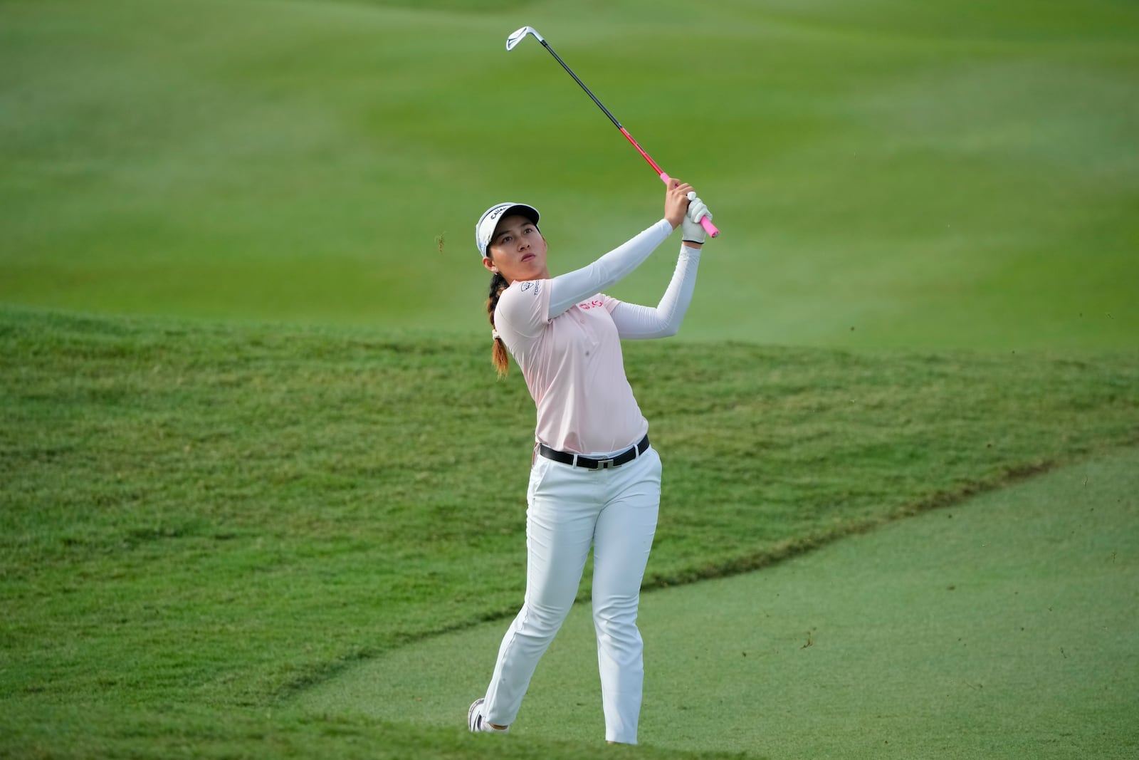 Jeeno Thitikul of Thailand hits from a fairway at the 2nd fairway during the first round of Maybank LPGA Championship golf tournament at Kuala Lumpur Golf and Country club in Kuala Lumpur, Thursday, Oct. 24, 2024. (AP Photo/Vincent Thian)