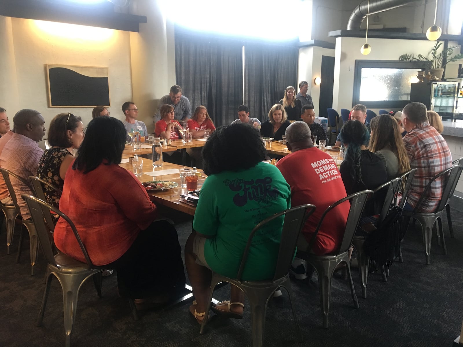 Singer John Legend dines with Dayton Mayor Nan Whaley and a group that includes members of Moms in Action during his Aug. 11, 2019, visit to the Oregon District. CONTRIBUTED PHOTO FROM NATALIE SKILLITER OR CORNER KITCHEN