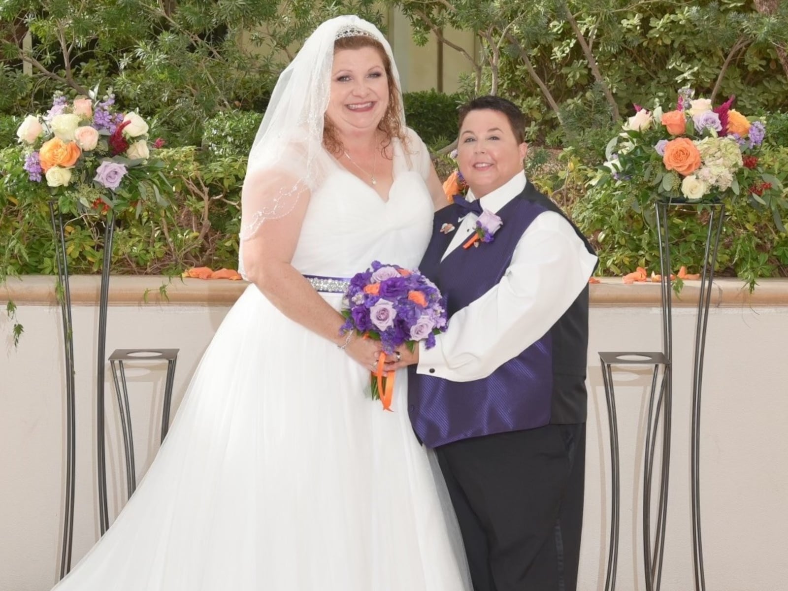 Amy Stuven (left) and Chris Williford (right) got married on the one-year anniversary of the 2017 Route 91 Harvest Music Festival mass shooting. Williford, a survivor of the shooting, wanted to change the meaning of that day and place, so she and her wife, Stuven, decided to get married there. The orange and purple colors are in memory of the victims of that Las Vegas shooting. COURTESY PHOTO