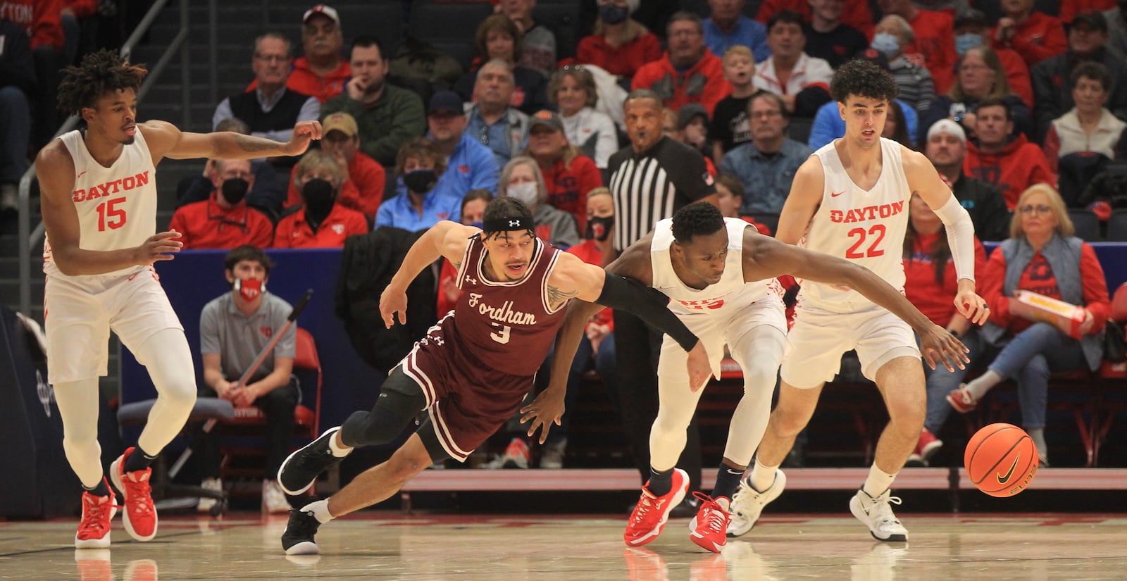 Dayton's R.J. Blakney chases a ball against Fordham's Darius Quisenberry on Tuesday, Jan. 25, 2022, at UD Arena. David Jablonski/Staff