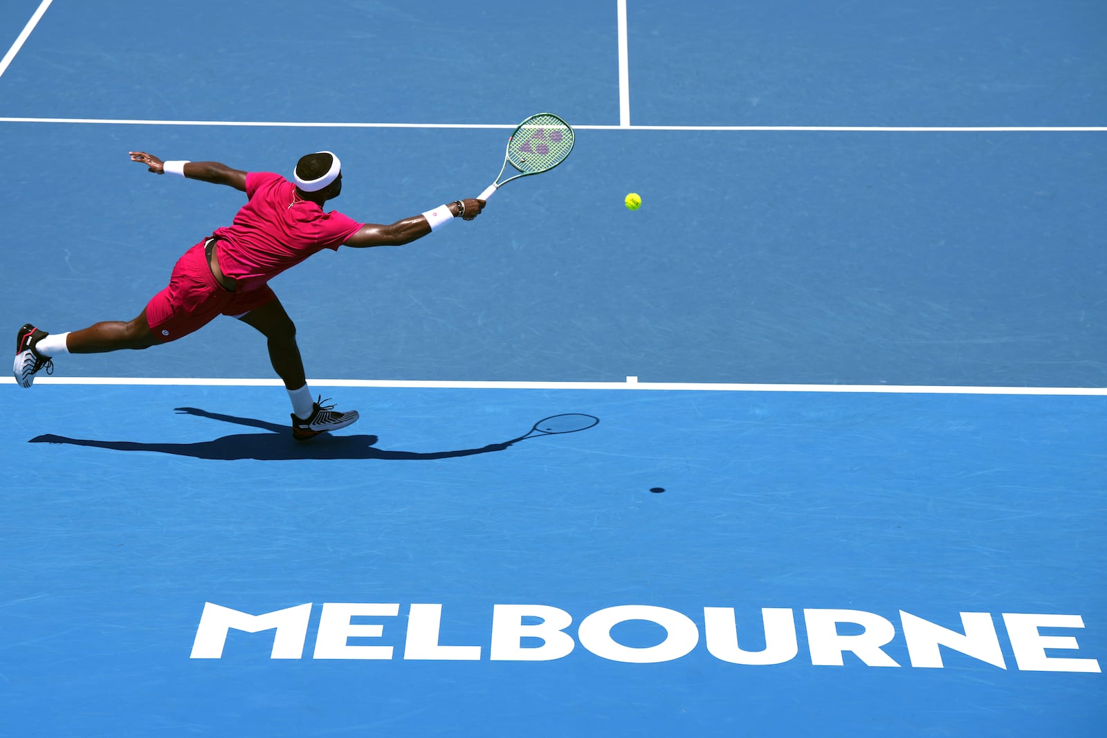 Frances Tiafoe of the U.S. plays a forehand return to Arthur Rinderknech of France during their first round match at the Australian Open tennis championship in Melbourne, Australia, Monday, Jan. 13, 2025. (AP Photo/Vincent Thian)