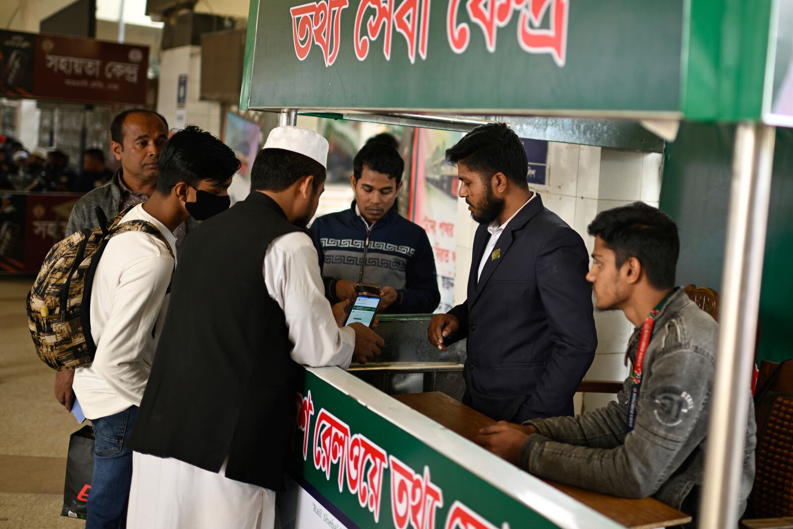 Stranded passengers enquire with an official at a railway station after trains across the country have been canceled as railway workers went on strike for higher pensions and other benefits, in Dhaka, Bangladesh, Tuesday, Jan. 28, 2025. (AP Photo/Mahmud Hossain Opu)