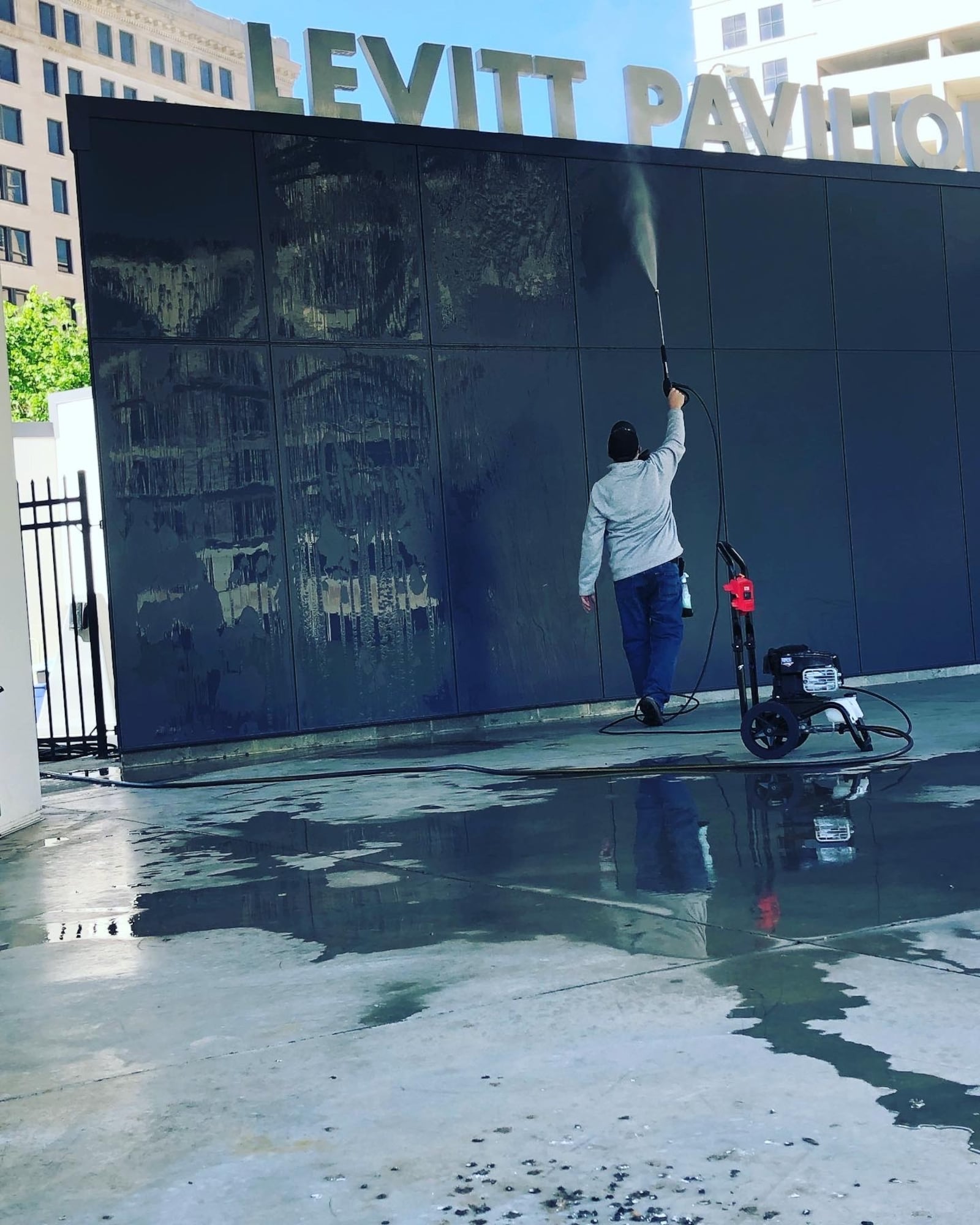 A volunteer pressure washes the stage at Levitt Pavilion, preparing for this summer's concert series. CONTRIBUTED