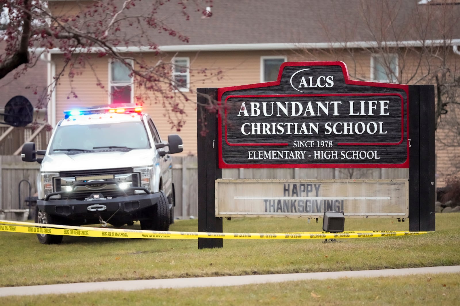 Emergency vehicles are parked outside the Abundant Life Christian School in Madison, Wis., following a shooting, Monday, Dec. 16, 2024. (AP Photo/Morry Gash)