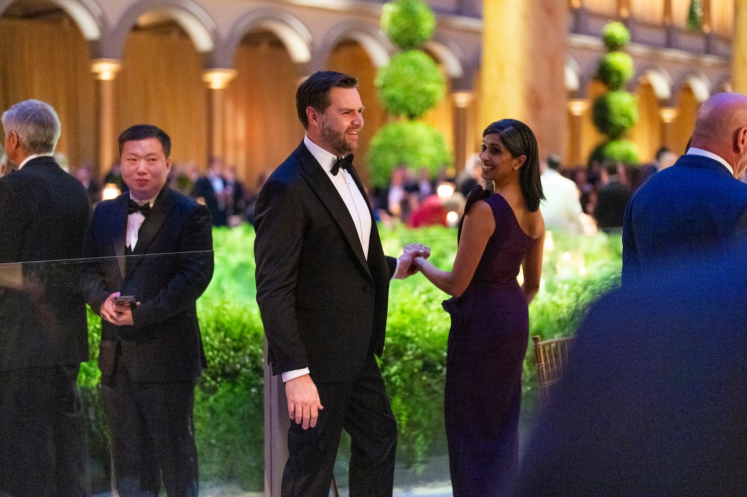 
                        Vice President-elect JD Vance and his wife Usha Vance wait for President-elect Donald Trump’s arrival during a candlelight dinner at the National Building Museum in Washington on Sunday, Jan. 19, 2025, the day before Trump’s inauguration. (Doug Mills/The New York Times)
                      