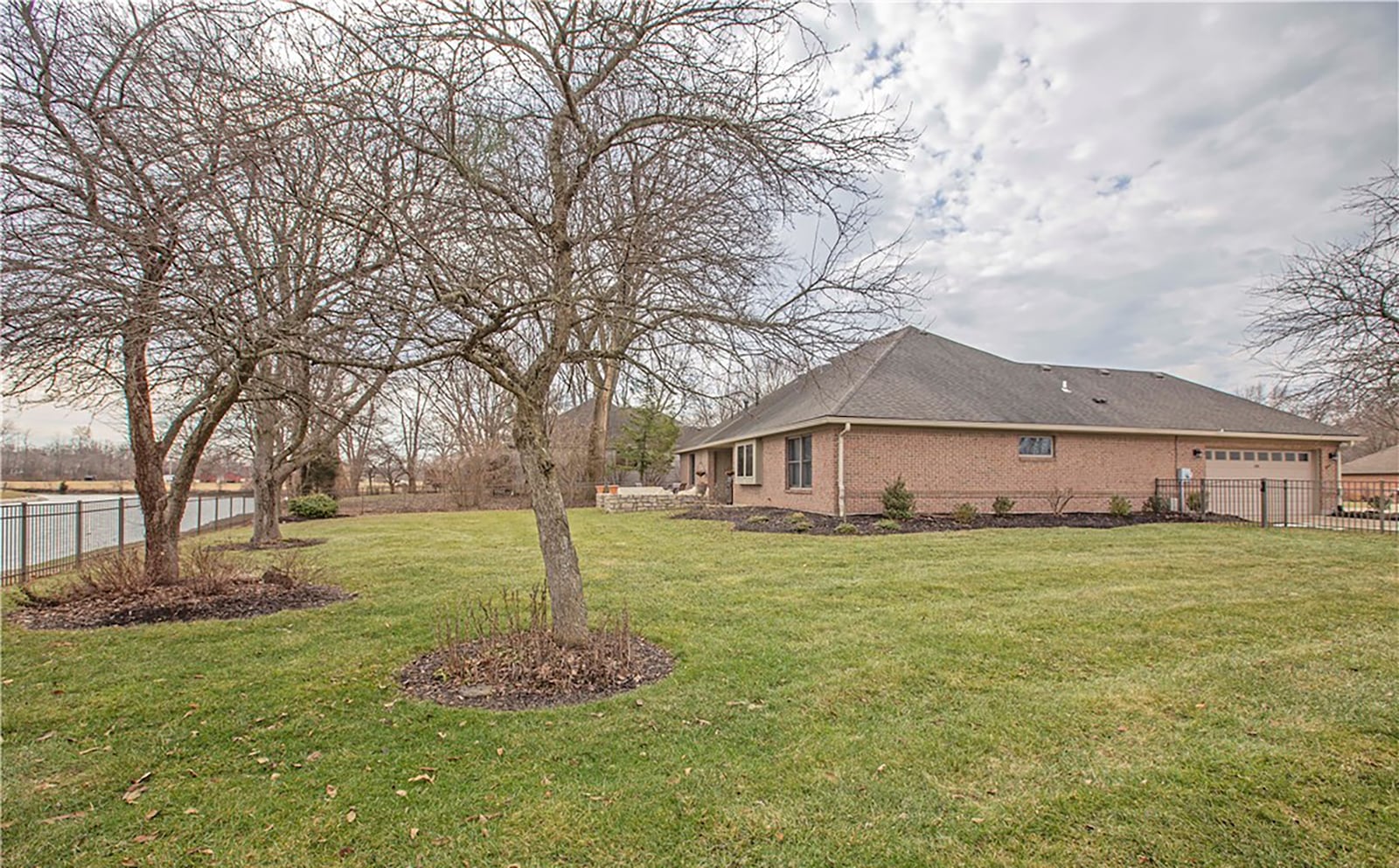 The home has a two car attached side entry garage and is fully fenced to the side and rear. It overlooks a lake.