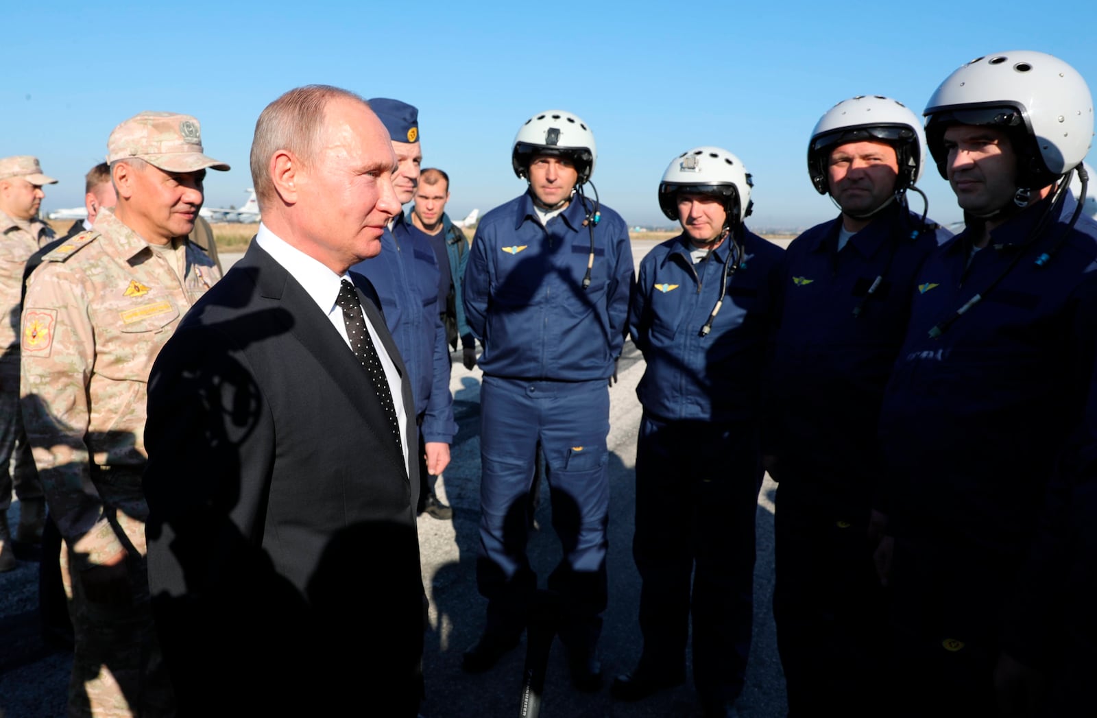 FILE - Russian President Vladimir Putin, second left, chats with Russian pilots at the Hemeimeem air base in Syria, on Dec. 11, 2017. (Mikhail Klimentyev, Sputnik, Kremlin Pool Photo via AP, File)