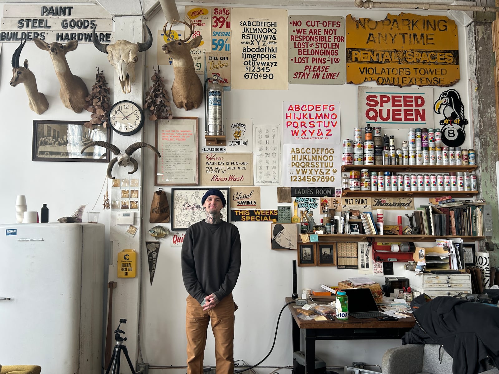 Sign painter Josh Flohre, owner of Ink & Hammer, in his studio in Dayton's Davis-Linden building. Flohre has an extensive inspiration collection of antique signs and documents.