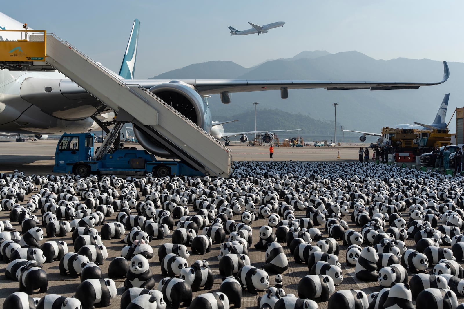 Part of the 2500 panda sculptures are displayed at the Hong Kong International Airport during the welcome ceremony of the panda-themed exhibition "Panda Go!" in Hong Kong, Monday, Dec. 2, 2024. (AP Photo/Chan Long Hei)