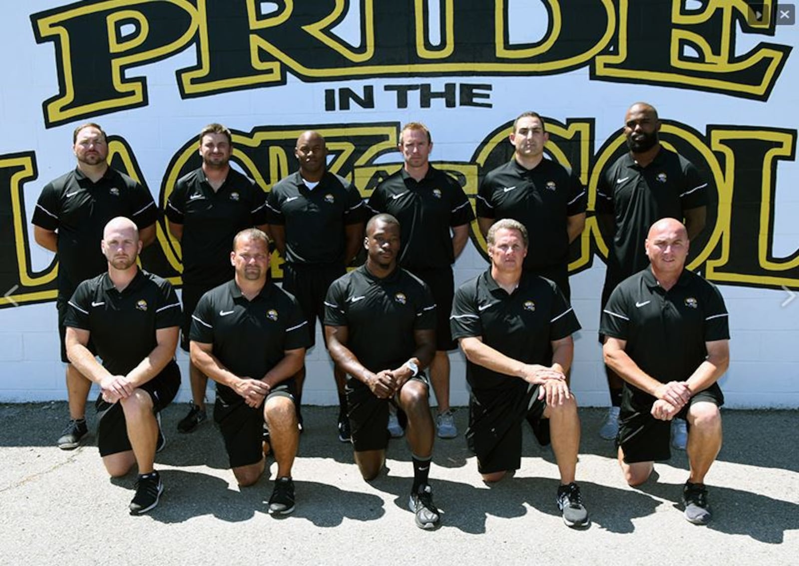 P.K. Sam (top row, far right) is the wide receivers coach for the Centerville Elks in Centerville, Ohio.