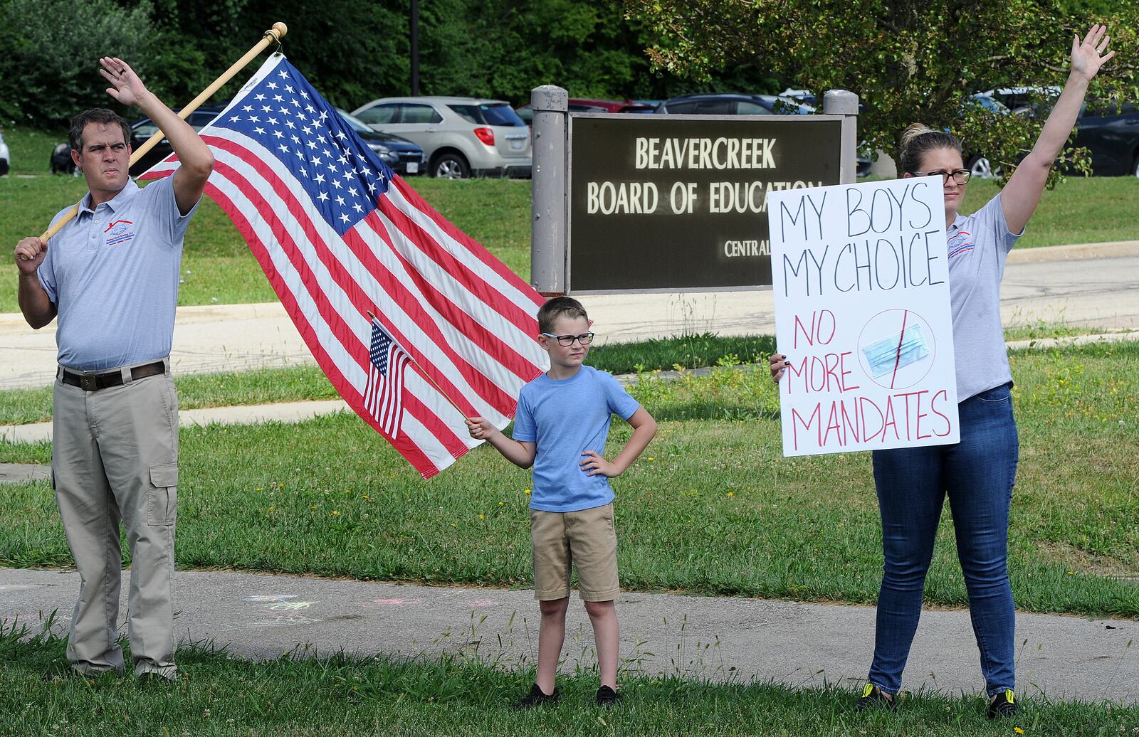 A group of about 14 people stood outside the Beavercreek Board of Education office Wednesday Aug. 18, 2021, to protest the mandate for students to wear masks in classes. MARSHALL GORBY\STAFF