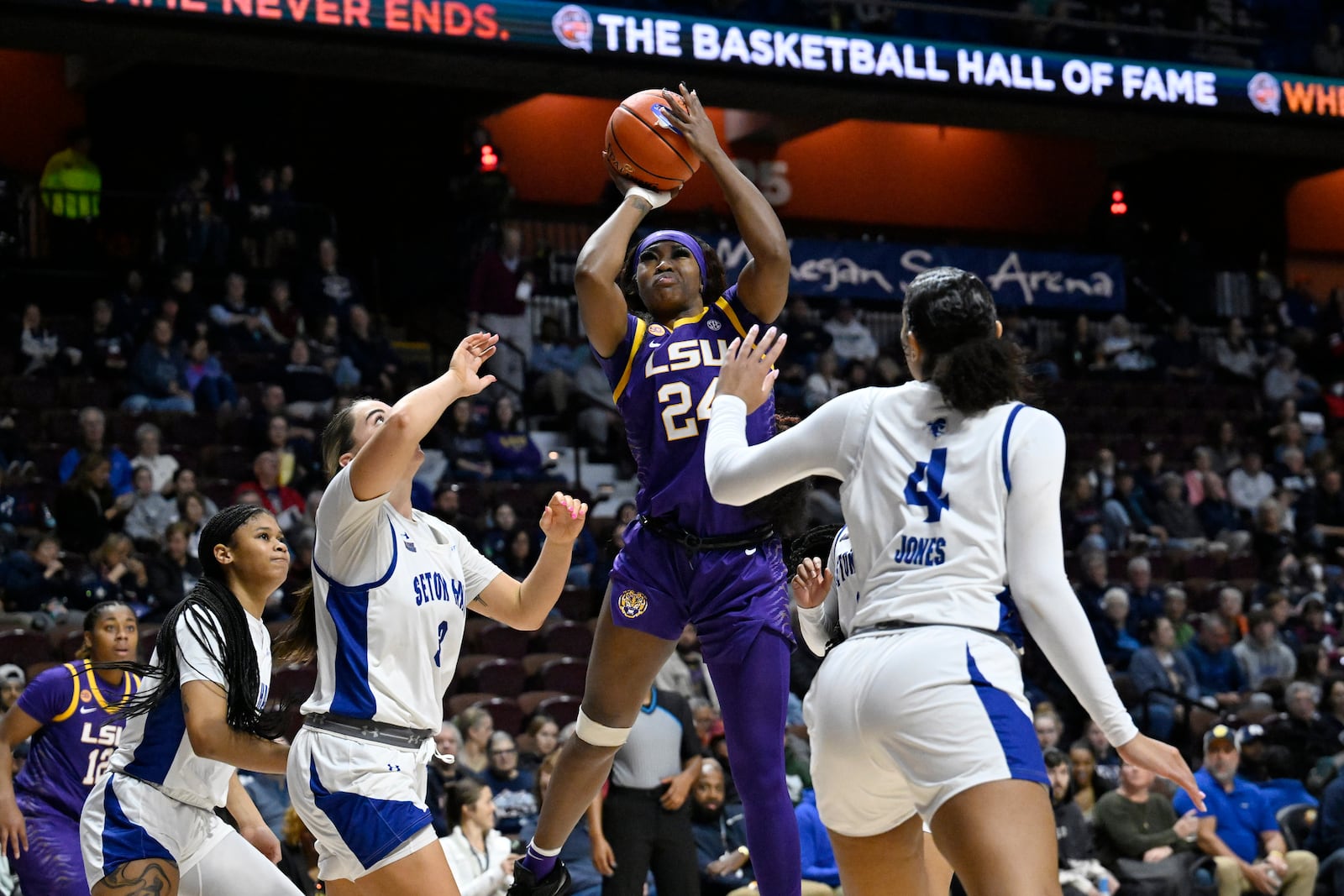 LSU guard Aneesah Morrow (24) shoots over Seton Hall forward Faith Masonius (3) and Seton Hall forward Savanna Jones (4) in the second half of an NCAA college basketball game, Tuesday, Dec. 17, 2024, in Uncasville, Conn. (AP Photo/Jessica Hill)