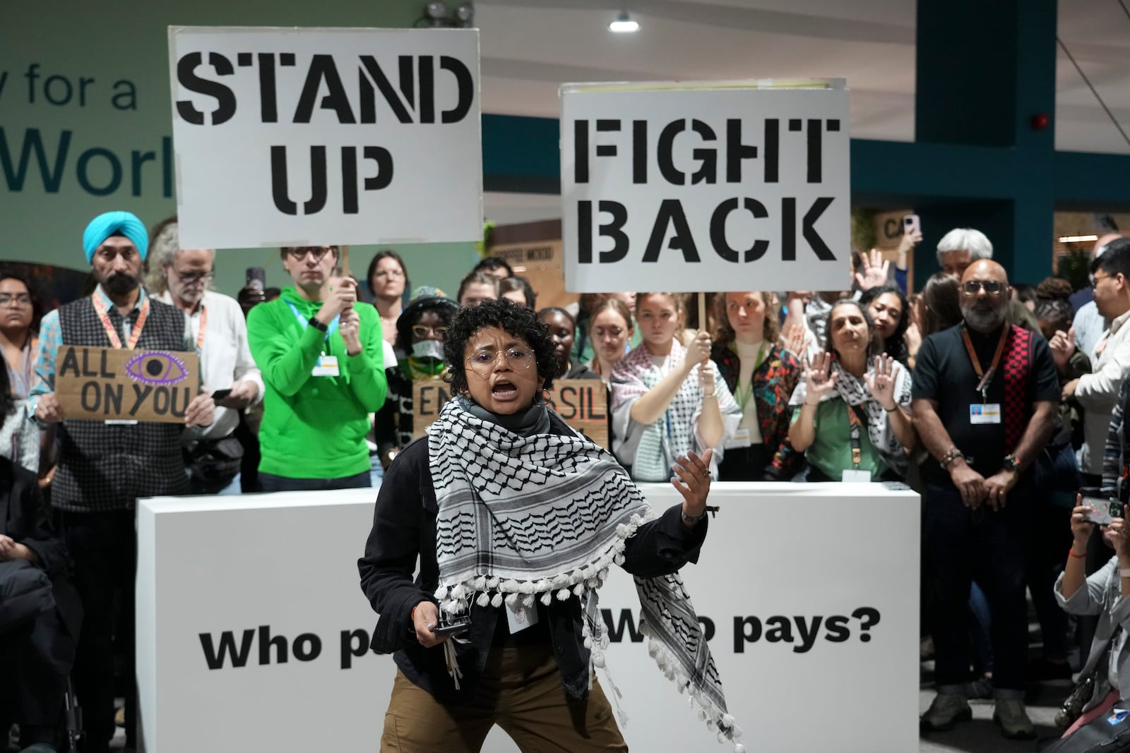 Activists participate in a demonstration for climate finance at the COP29 U.N. Climate Summit, Saturday, Nov. 23, 2024, in Baku, Azerbaijan. (AP Photo/Sergei Grits)