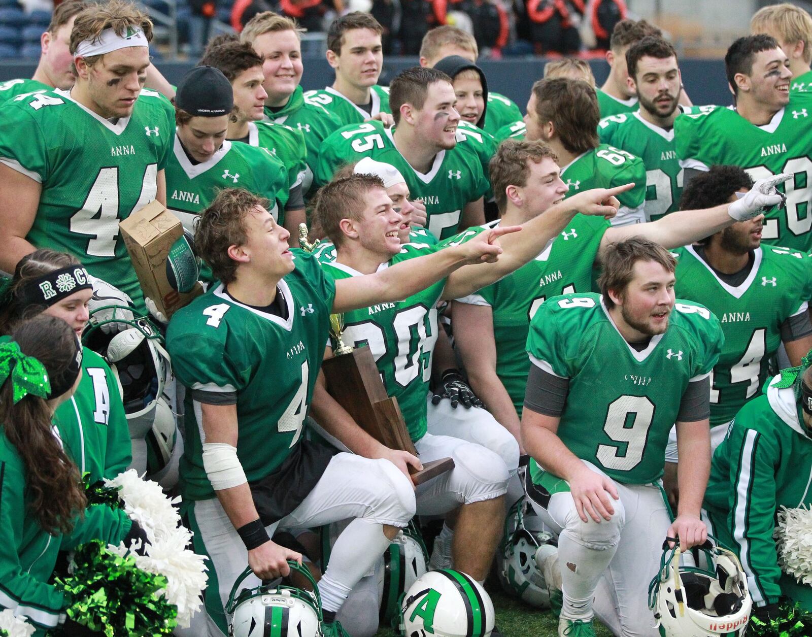 Bart Bixler (4) and Riley Huelskamp (20) of Anna celebrate a 48-14 defeat of New Middletown Springfield 48-14 in the Division VI high school football state championship at Tom Benson Hall of Fame Stadium in Canton on Friday, Dec. 6, 2019. MARC PENDLETON / STAFF