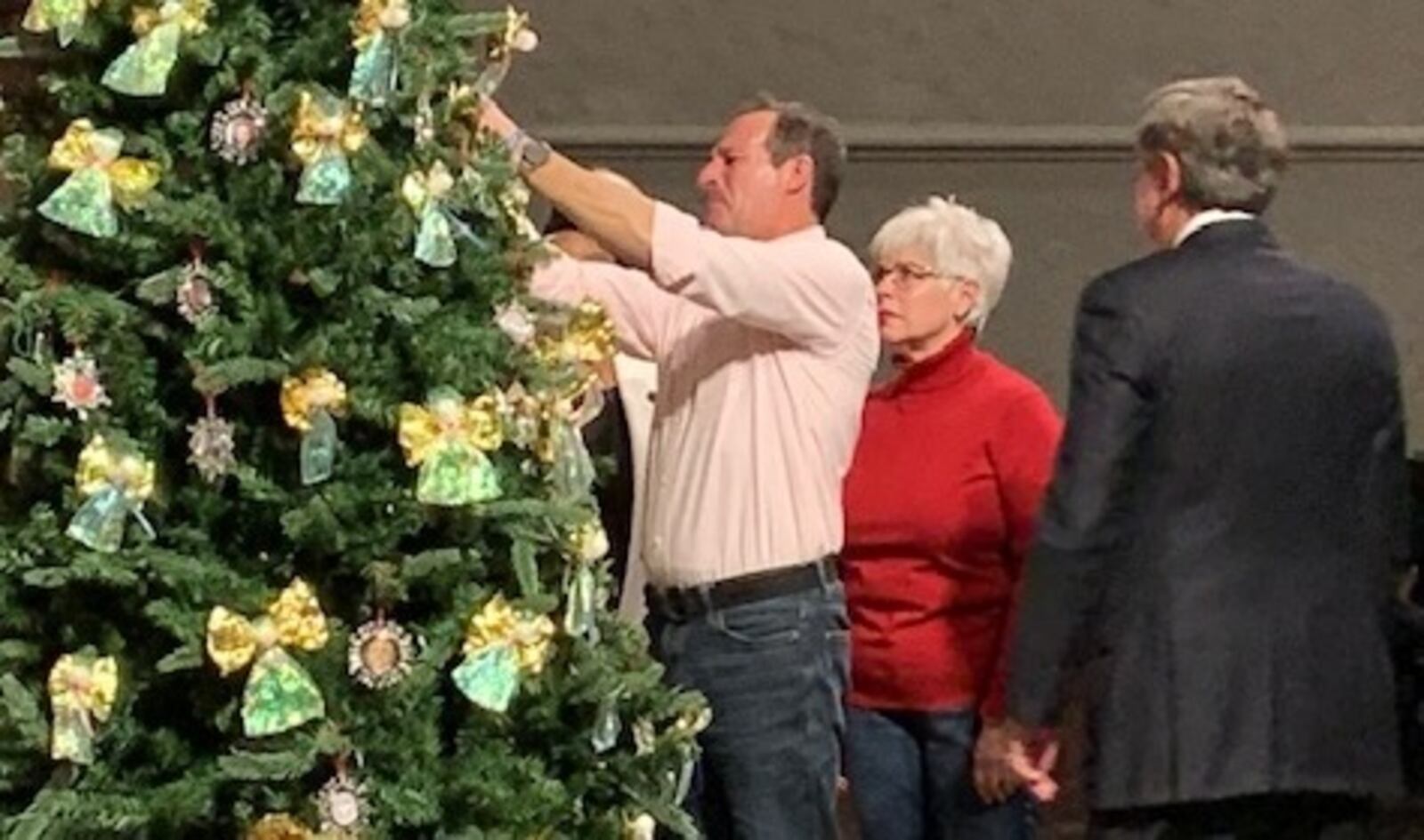 Ron and Vicky Cumer parents of Nicholas Cumer, one of nine innocent victims of the Oregon District mass shooting Aug. 4, 2019, in Dayton, adds a memorial ornament during the 29th annual Homicide Victims Memorial Service Dec. 9, 2019, at Westminster Presbyterian Church in downtown Dayton. The Cumers traveled from Pennsylvania to honor their son.