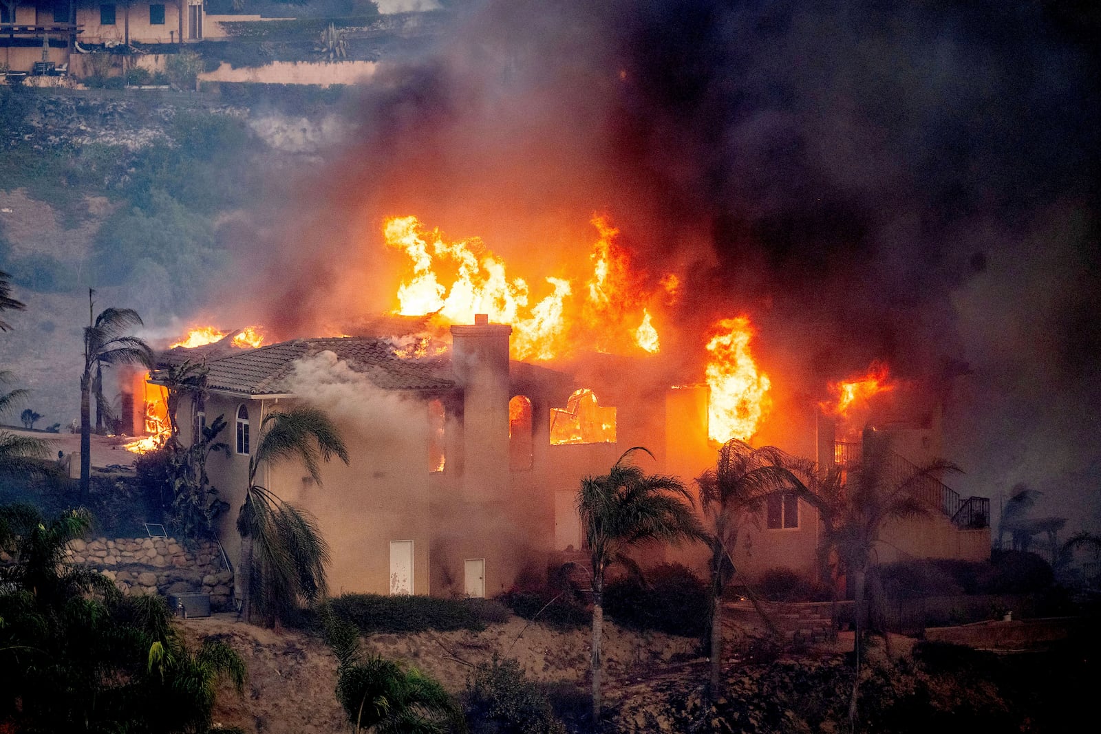 Flames consume a home as the Mountain Fire burns in Camarillo, Calif., on Wednesday, Nov. 6, 2024. (AP Photo/Noah Berger)