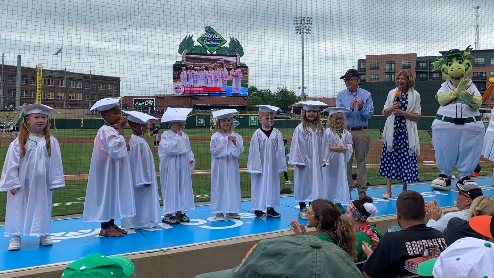 Gov. Mike DeWine and Ohio First Lady Fran DeWine celebrate local children graduating from Dolly Parton's Imagination Library of Ohio during the Dayton Dragons game on Sunday, Aug. 14, 2022. Dolly Parton's Imagination Library of Ohio provides sends books monthly to children under the age of five, at no cost to families. CONTRIBUTED\DOLLY PARTON'S IMAGINATION LIBRARY OF OHIO