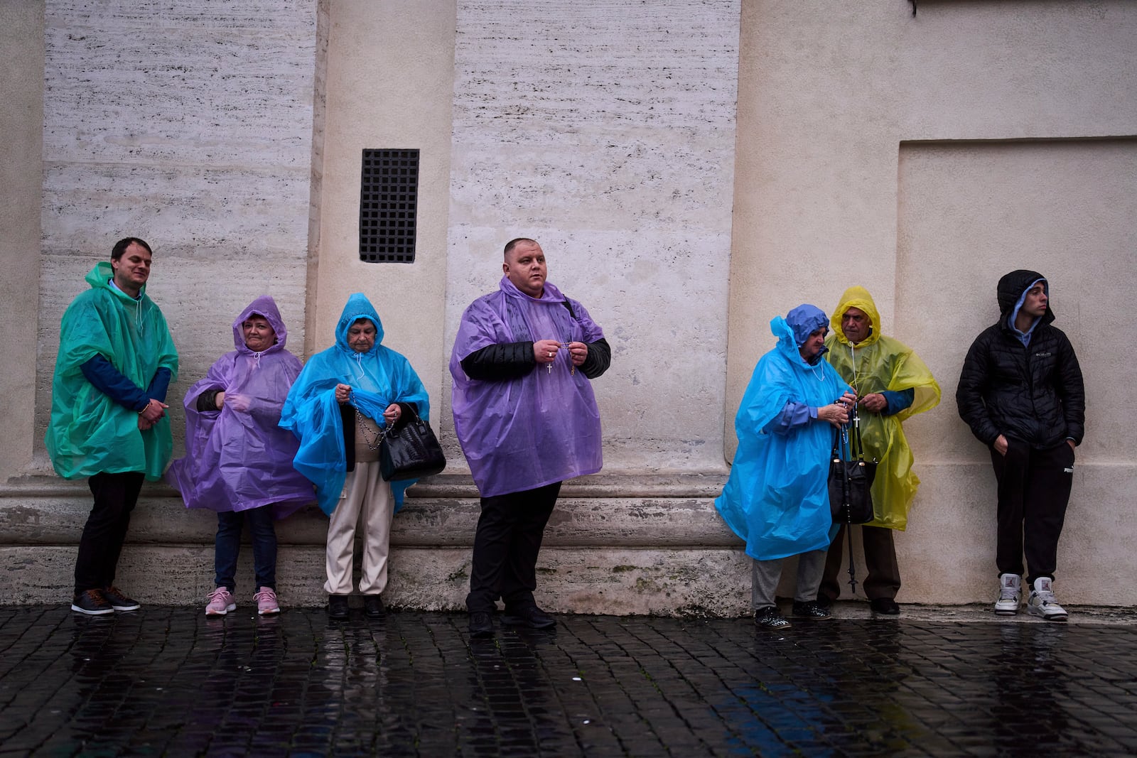 People pray as they follow a live broadcasted Rosary prayer for Pope Francis, in St. Peter's Square at the Vatican, Wednesday, March 12, 2025. (AP Photo/Francisco Seco)