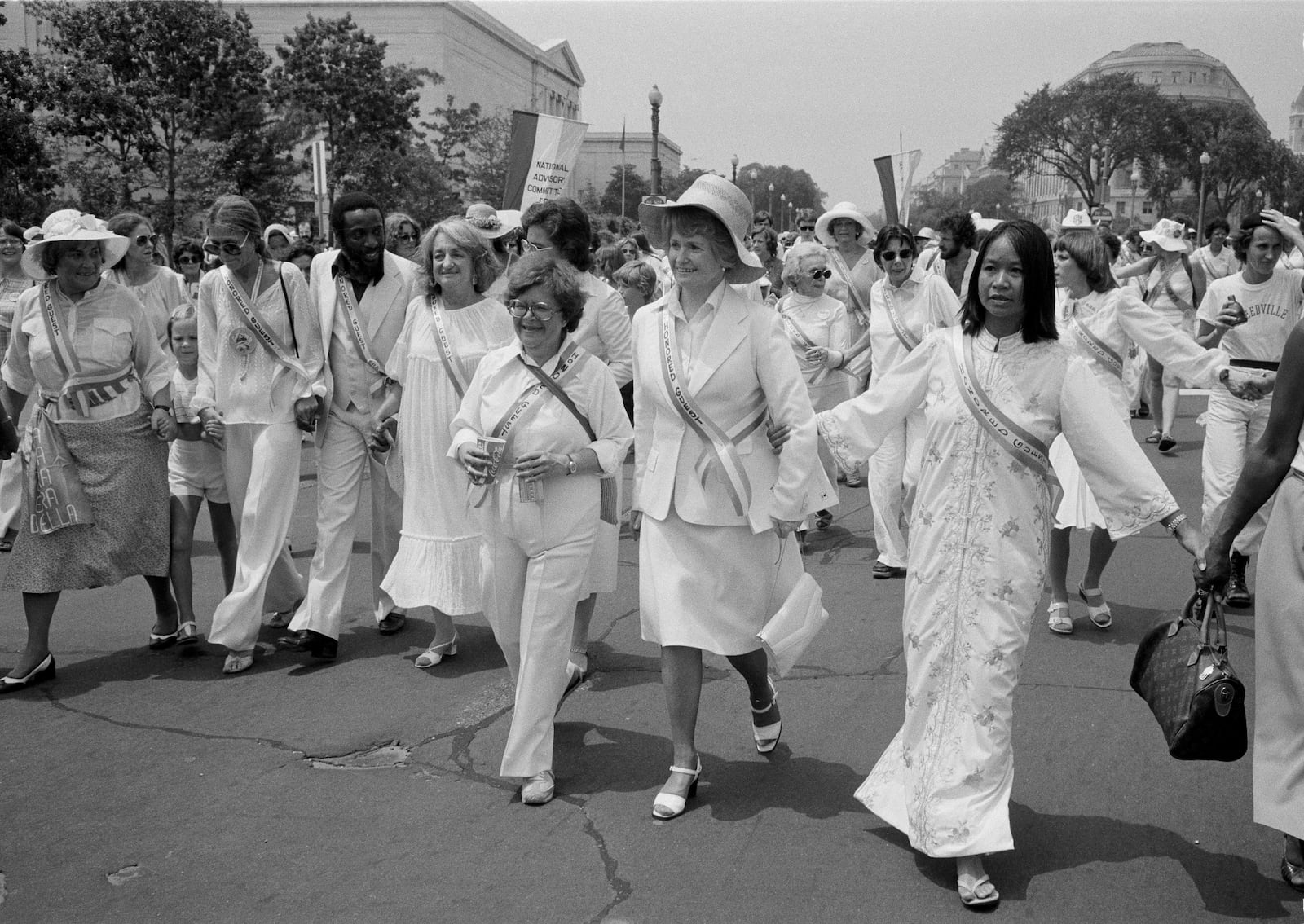 FILE - Leading supporters of the Equal Rights Amendment march in Washington, July 9, 1978, urging Congress to extend the time for ratification of the ERA. From left are: Gloria Steinem; Dick Gregory; Betty Friedan; Rep. Elizabeth Holtzman, D-N.Y. (partially obscured); Rep. Barbara Mikulski, D-Md.; and Rep. Margaret Heckler, R-Mass. The women at far left and right are unidentified. (AP Photo/Dennis Cook, File)