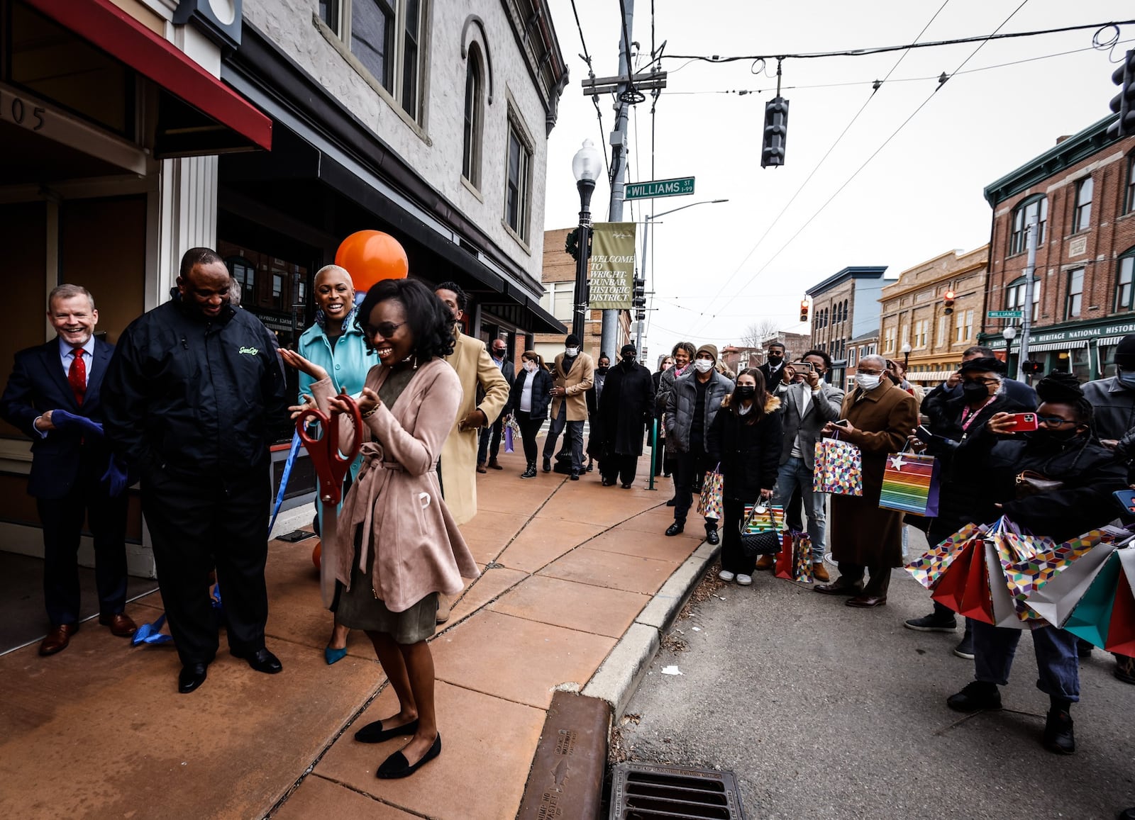 Whitney Barkley, Director of the Greater West Dayton Incubator, reacts to the ribbon cutting of the new Entrepreneur's Center on West Third St. in Dayton. JIM NOELKER/STAFF