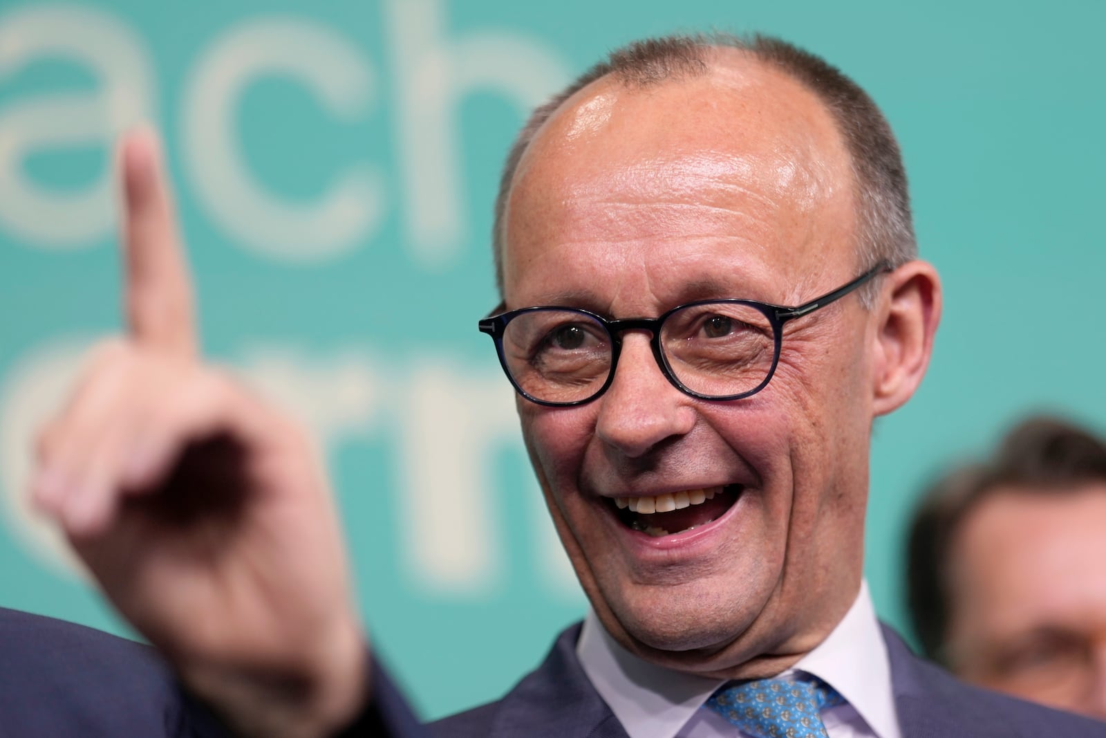 Friedrich Merz, the candidate of the mainstream conservative Christian Democratic Union party, reacts to the speech of Markus Soeder, leader of CSU and Minister-President of Bavaria, at the party headquarters in Berlin, Germany, Sunday, Feb. 23, 2025, after the German national election. (AP Photo/Markus Schreiber)