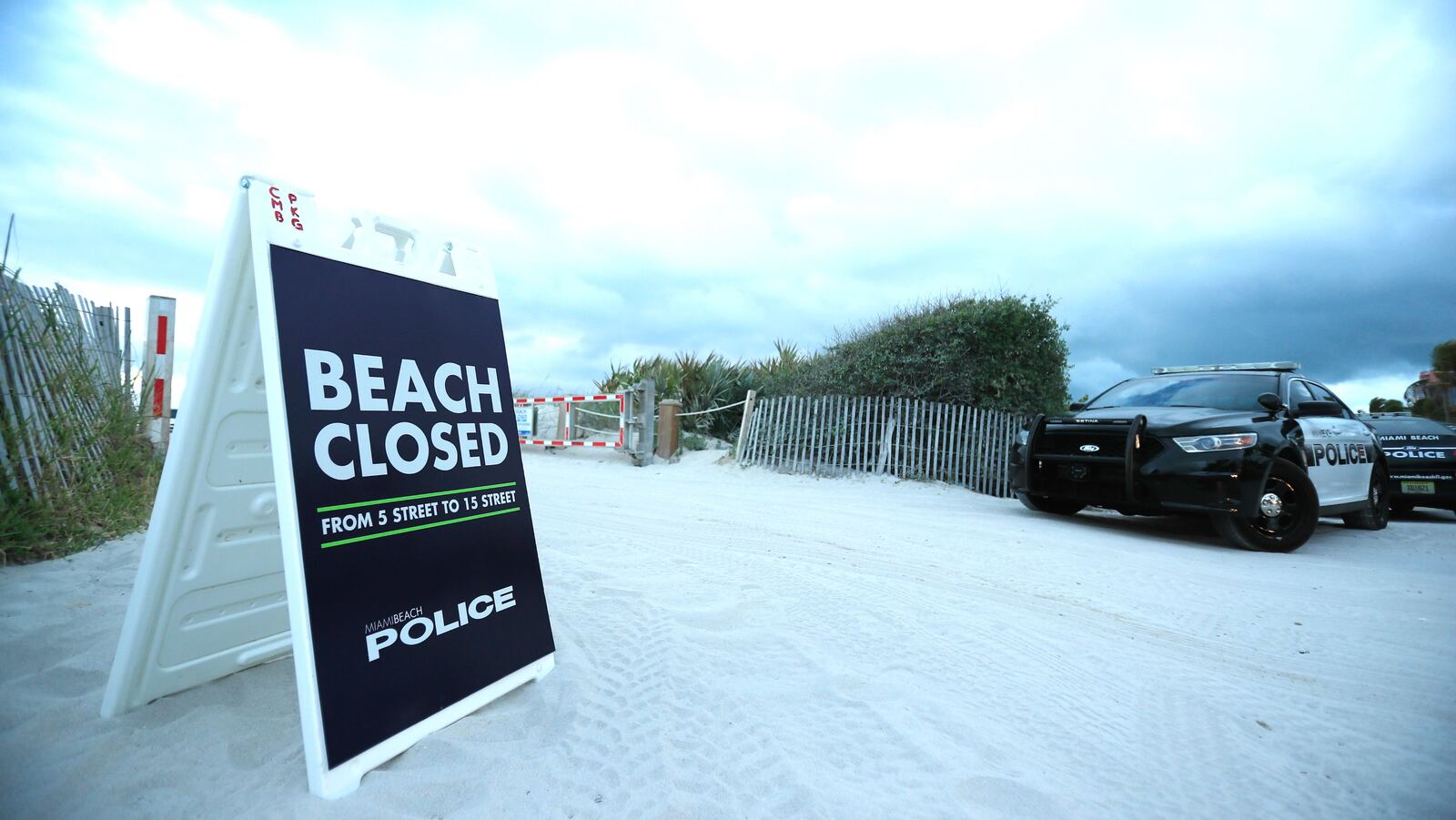 A sign shows an area of South Beach is closed on March 17, 2020, in Miami Beach, Fla. Miami Beach city officials closed the area of the beach popular with college spring breakers in a bid to keep COVID-19 from spreading.