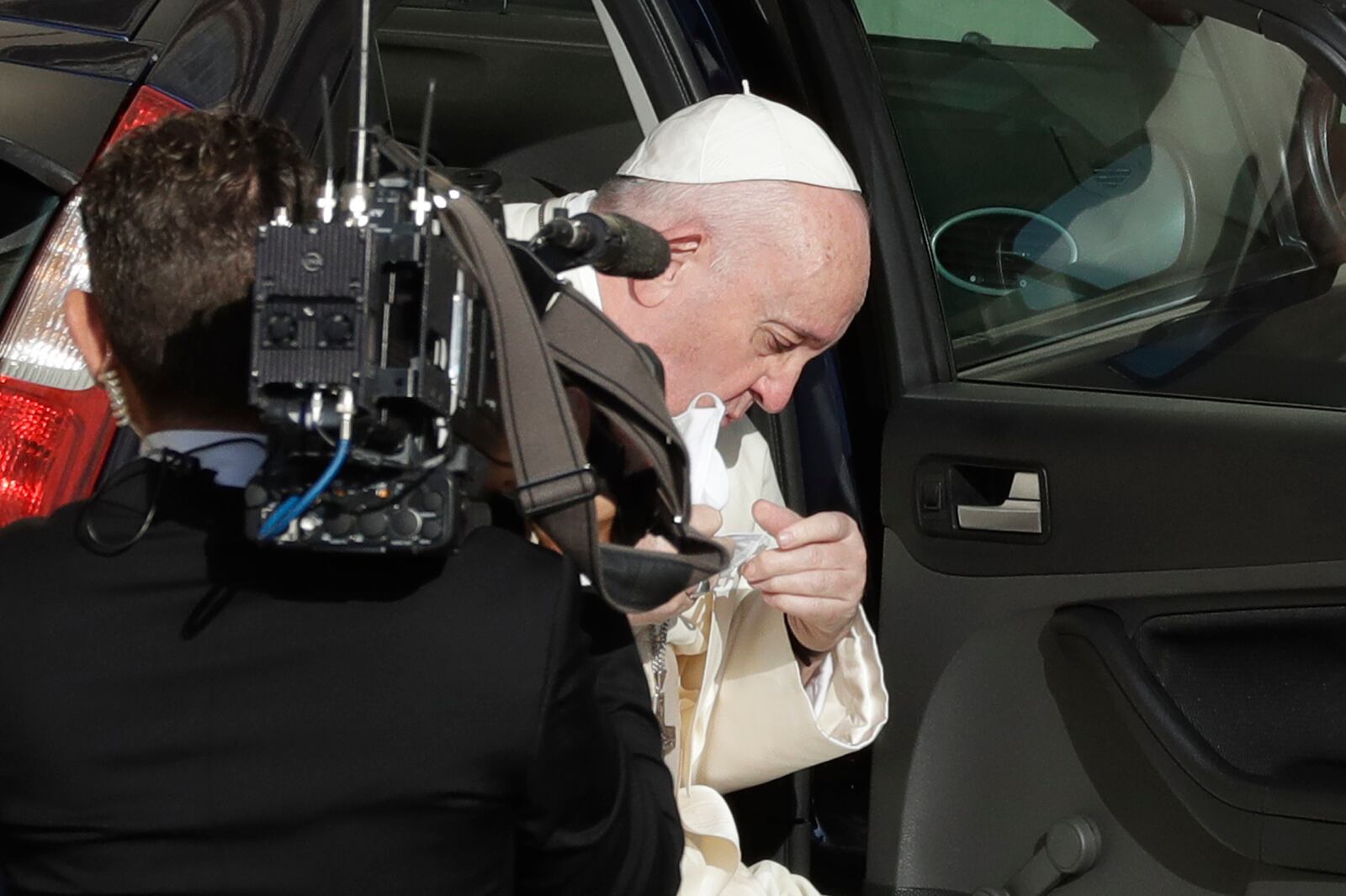 Pope Francis takes off his face mask as he arrives during his weekly general audience in San Damaso courtyard at the Vatican, Wednesday, Sept. 9, 2020. (AP Photo/Andrew Medichini)