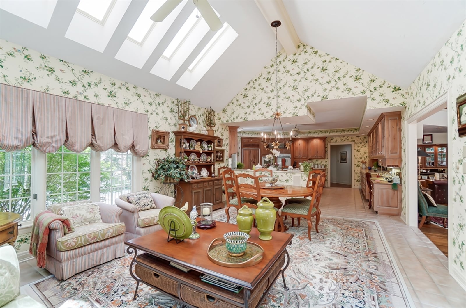 A cathedral ceiling above the breakfast and morning room has seven skylights and a Palladian window. French doors open out from the morning room to the backyard.