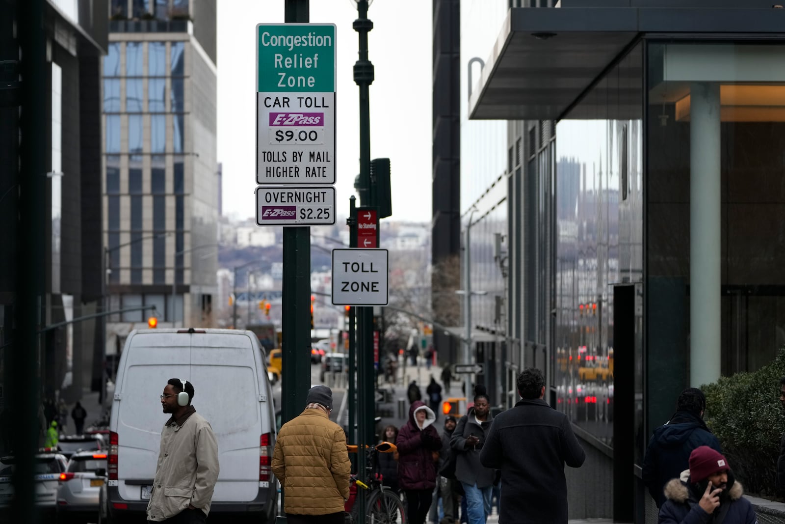 Signs advising drivers of congestion pricing tolls are displayed near the exit of the Lincoln Tunnel in New York, Wednesday, Feb. 19, 2025. (AP Photo/Seth Wenig)