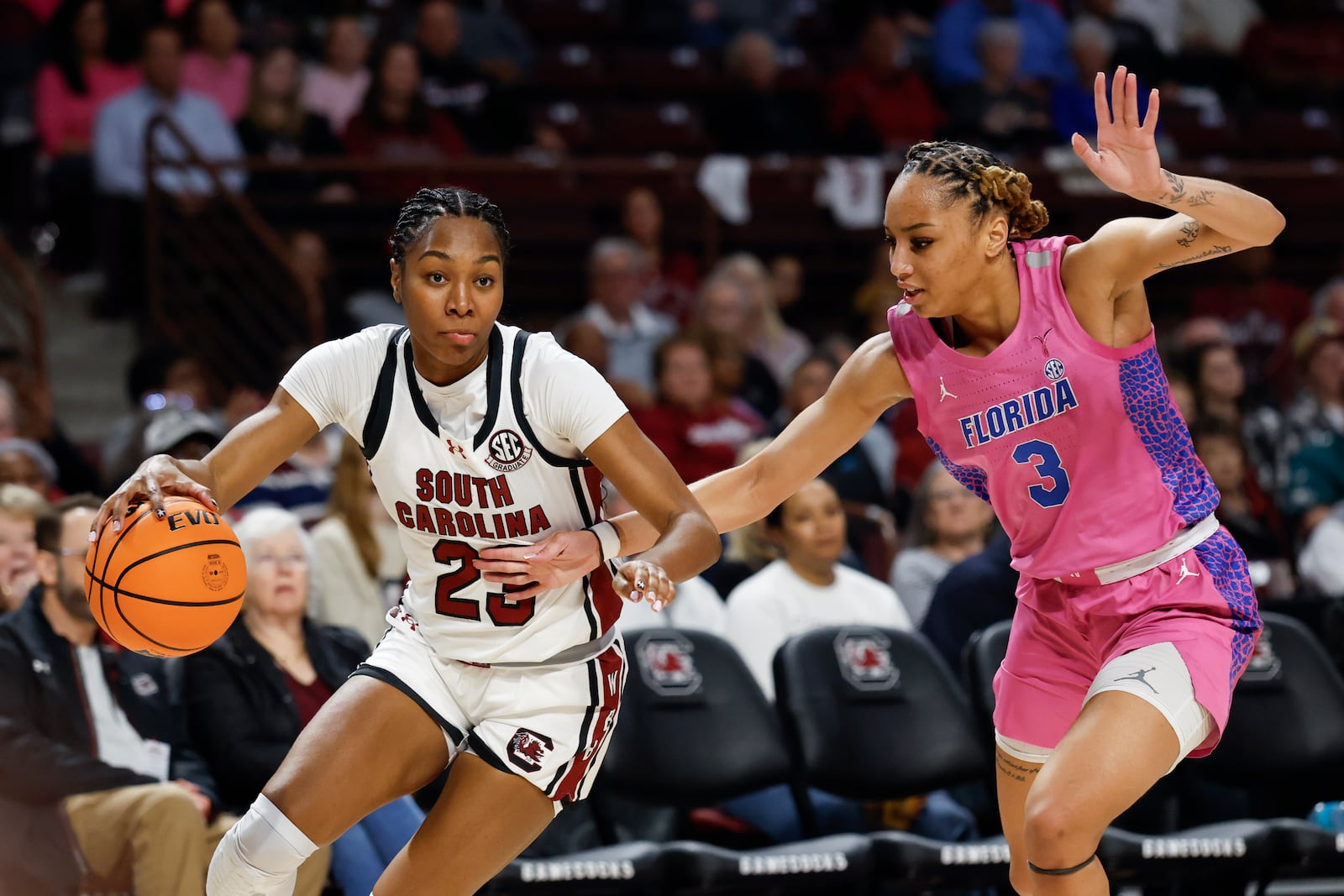 South Carolina guard Bree Hall, left, drives past Florida forward Alexia Gassett (3) during the first half of an NCAA college basketball game in Columbia, S.C., Thursday, Feb. 13, 2025. (AP Photo/Nell Redmond)