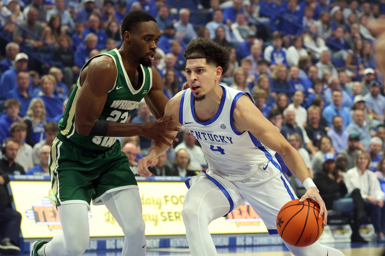 Kentucky's Koby Brea (4) drives with the ball while defended by Wright State's Jack Doumbia, left, during the first half of an NCAA college basketball game in Lexington, Ky., Monday, Nov. 4, 2024. (AP Photo/James Crisp)