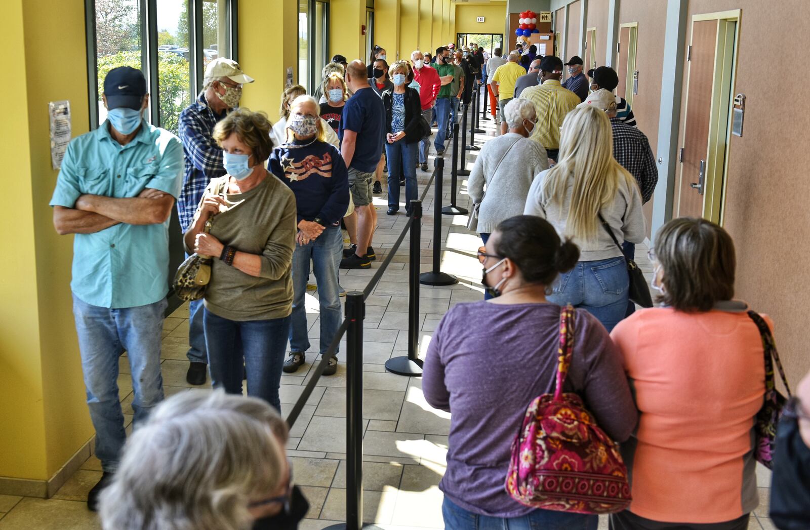 Voters line up at the Butler County Board of Elections on the first day of early voting Tuesday, October 6, 2020 in Hamilton. NICK GRAHAM / STAFF