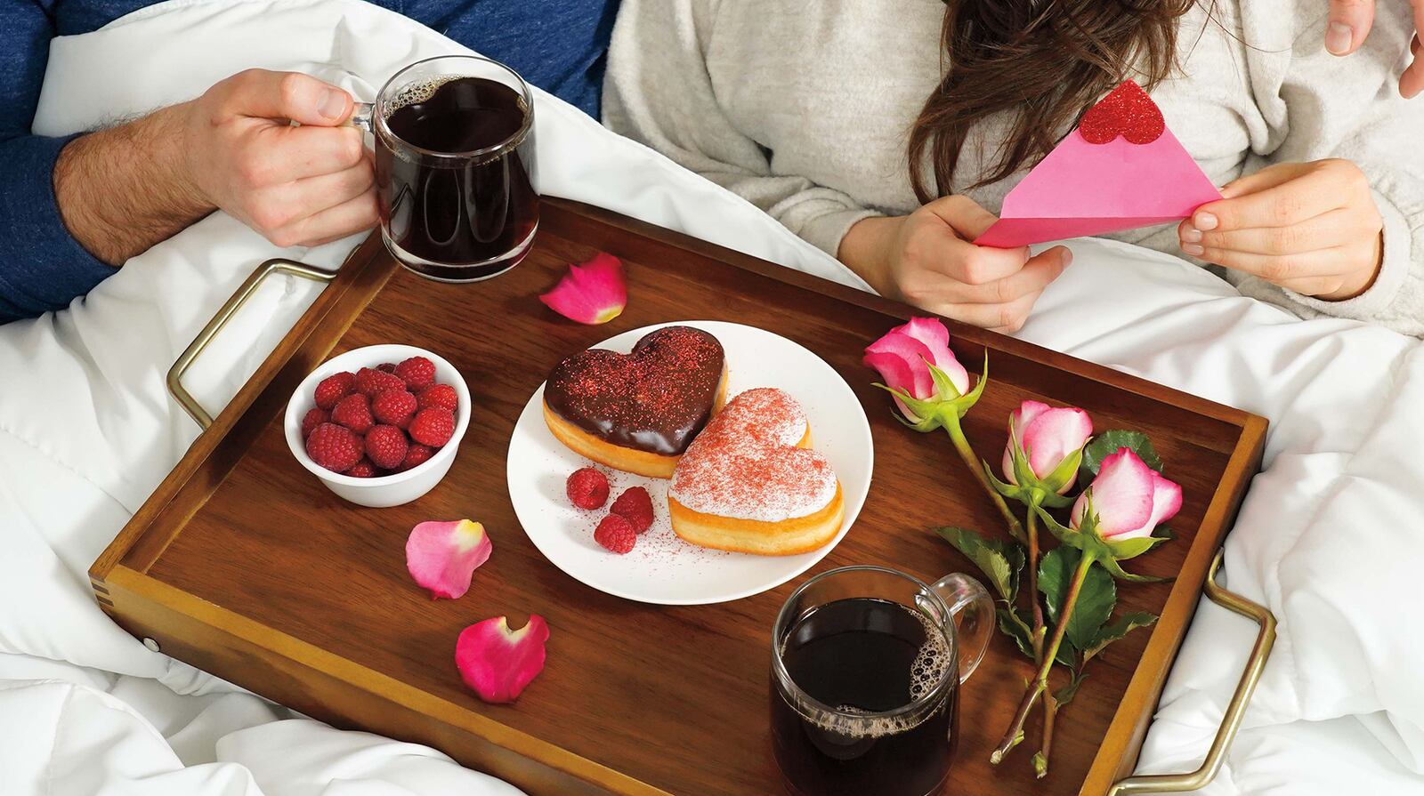 Tim Hortons' Vanilla Be Mine Donut is a raspberry-jam filled donut dipped in vanilla fondant topped with red shimmer, while the Chocolate Be Mine Donut is a venetian cream-filled donut dipped in chocolate fondant topped with red shimmer.  CONTRIBUTED PHOTO