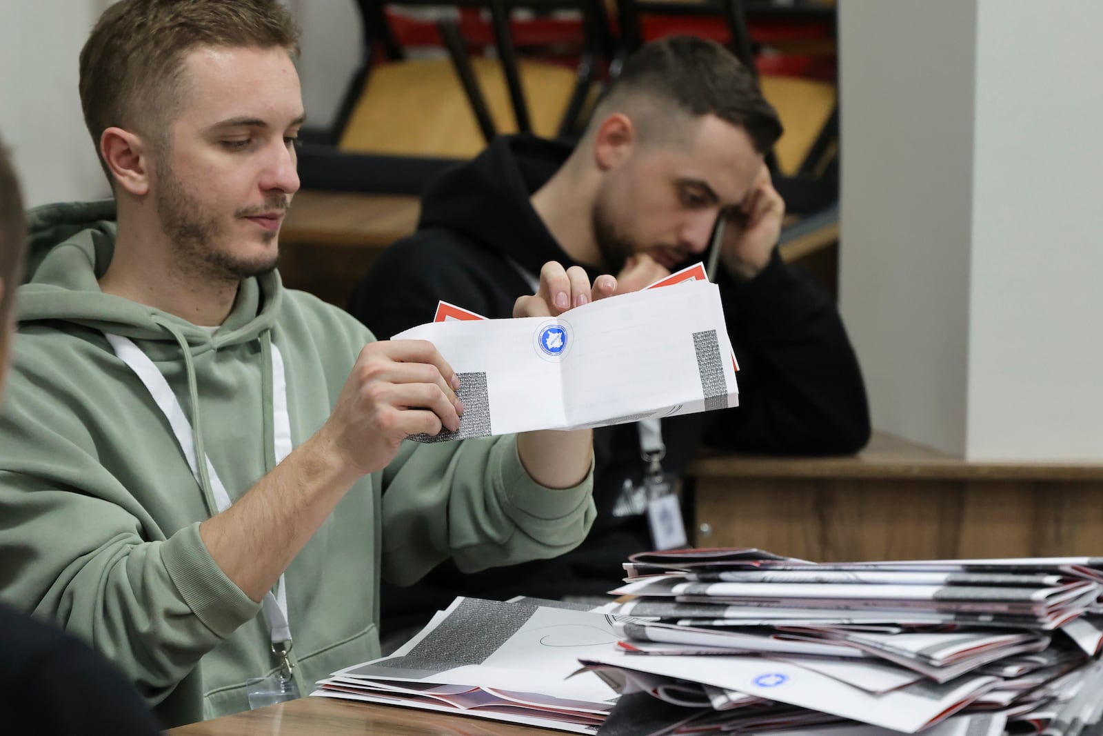 Members of an electoral committee count ballots during parliamentary election, in Pristina, Kosovo, Sunday, Feb. 9, 2025. (AP Photo/Vlasov Sulaj)