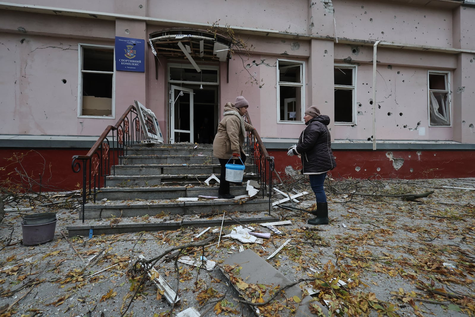 Women clear the rubble from a sports center damaged by a Russian strike in Zaporizhzhia, Ukraine, Nov. 11, 2024. (AP Photo/Kateryna Klochko)