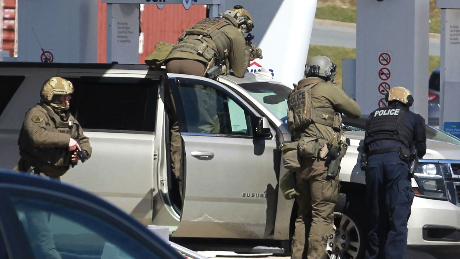 Royal Canadian Mounted Police officers surround a suspect at a gas station in Enfield, Nova Scotia, Sunday April 19, 2020. A total of 22 people were killed in the deadliest mass shooting in Canada in 30 years. Accused gunman Gabriel Wortman, 51, was killed in a shootout with police.