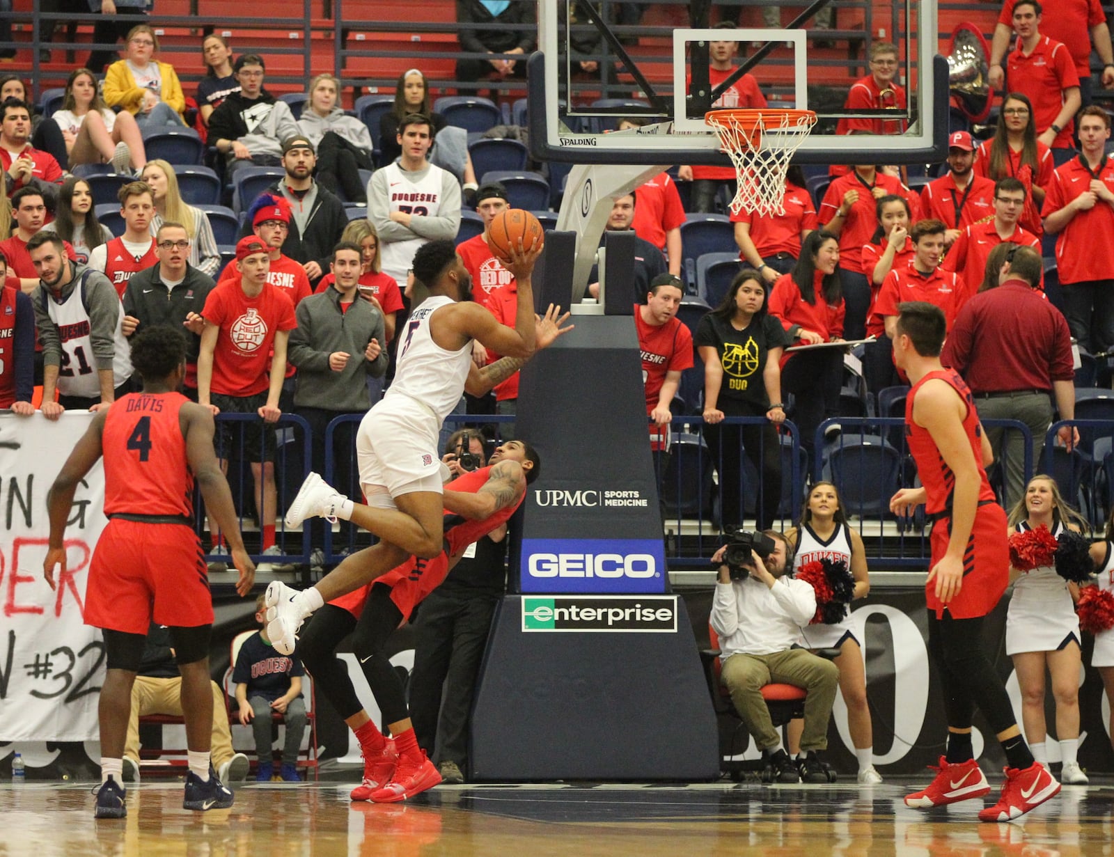 Duquesne’s Marcus Weathers runs into Dayton’s Obi Toppin on Saturday, March 9, 2019, at the Palumbo Center in Pittsburgh.