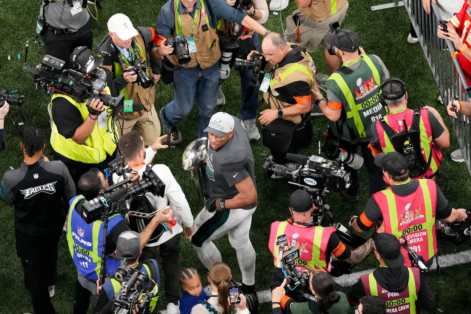 Philadelphia Eagles running back Saquon Barkley carries the Vince Lombardi Trophy after the Eagles won the NFL Super Bowl 59 football game against the Kansas City Chiefs, Sunday, Feb. 9, 2025, in New Orleans. (AP Photo/David J. Phillip)