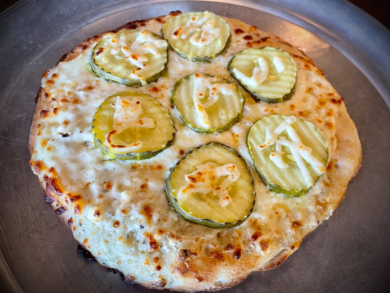 Crooked Handle Brewing Co. has two locations in the region: 123 N. Main St. in Piqua and 760 N. Main St. in Springboro. Pictured is the Dill Pickle Pizza. NATALIE JONES/STAFF