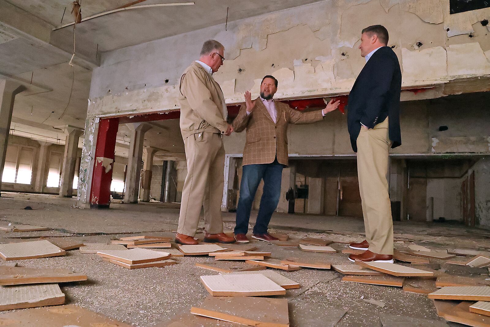 Ted Vander Roest, executive director of the Springfield Foundation, talks with John Landess and Daren Cotter, from the Turner Foundation, about the apartments that will be located in the upper floors of the Wren Building in downtown Springfield. BILL LACKEY/STAFF