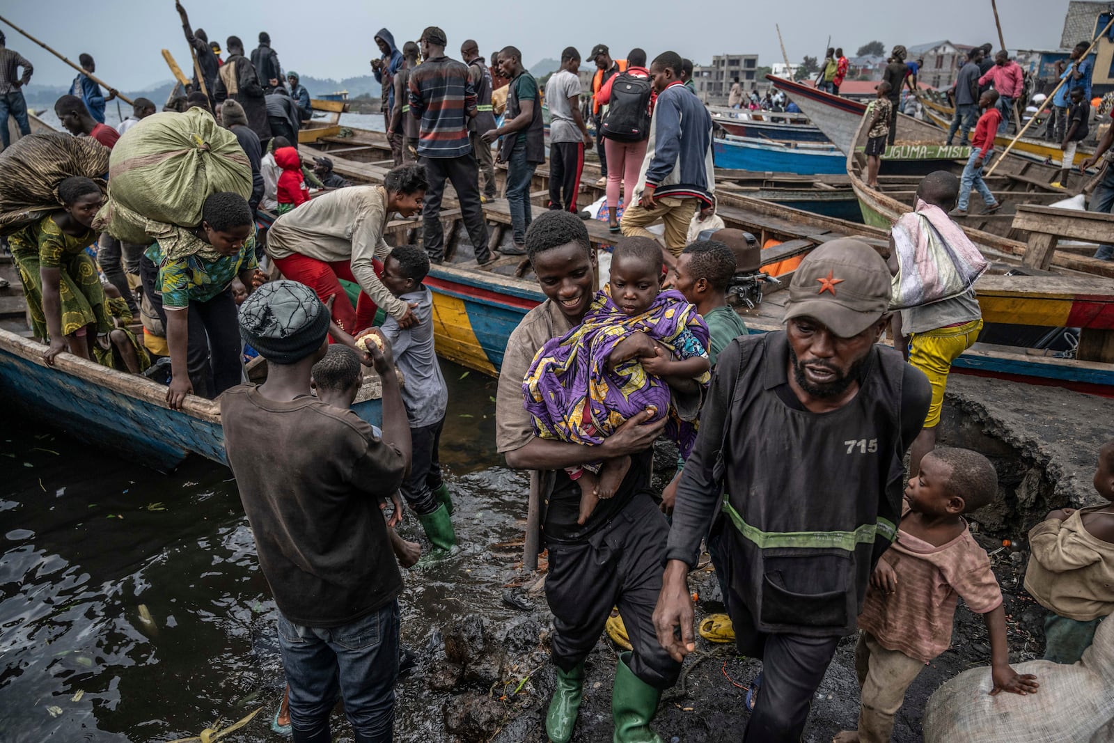 People fleeing M-23 rebel advances arrive by boat in Goma, Democratic Republic of the Congo, Wednesday, Jan. 22, 2025(AP Photo/Moses Sawasawa)