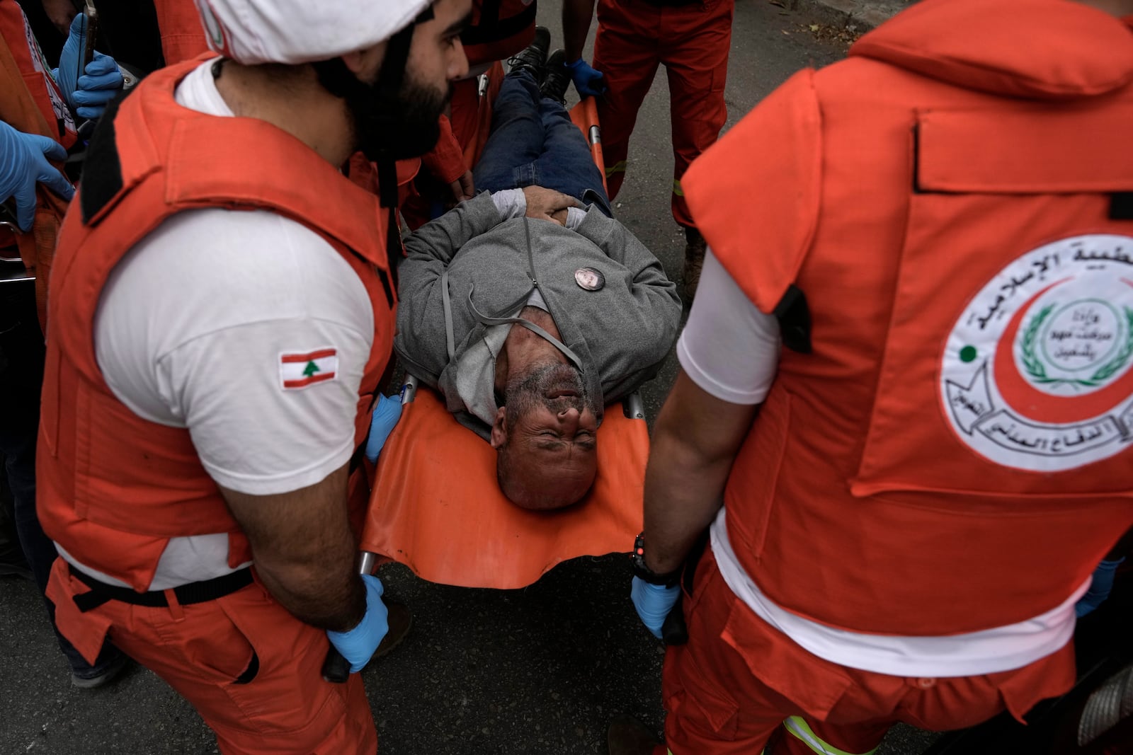 Rescuers evacuate a wounded man from the site of an Israeli airstrike that hit a building in central Beirut's Ras el-Nabaa neighborhood, Lebanon, Sunday, Nov. 17, 2024.(AP Photo/Bilal Hussein)