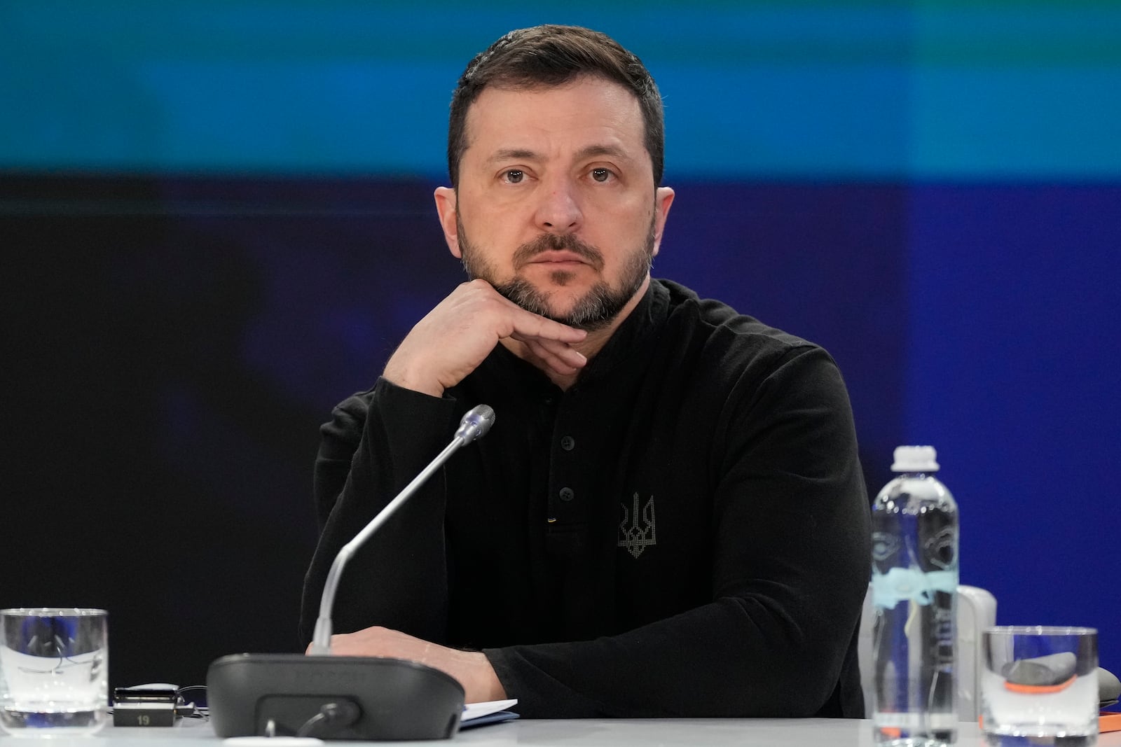 Ukrainian President Volodymyr Zelenskyy listens during a news conference at a security summit in Kyiv, Ukraine, Monday, Feb. 24, 2025. (Frank Gunn/The Canadian Press via AP)