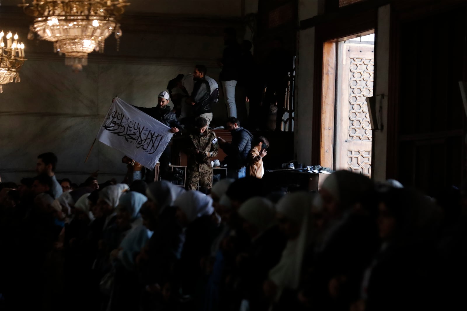 Syrians attend Friday prayers inside the 7th century Umayyad Mosque in Damascus, Syria, Friday, Dec. 13, 2024. (AP Photo/Omar Sanadiki)