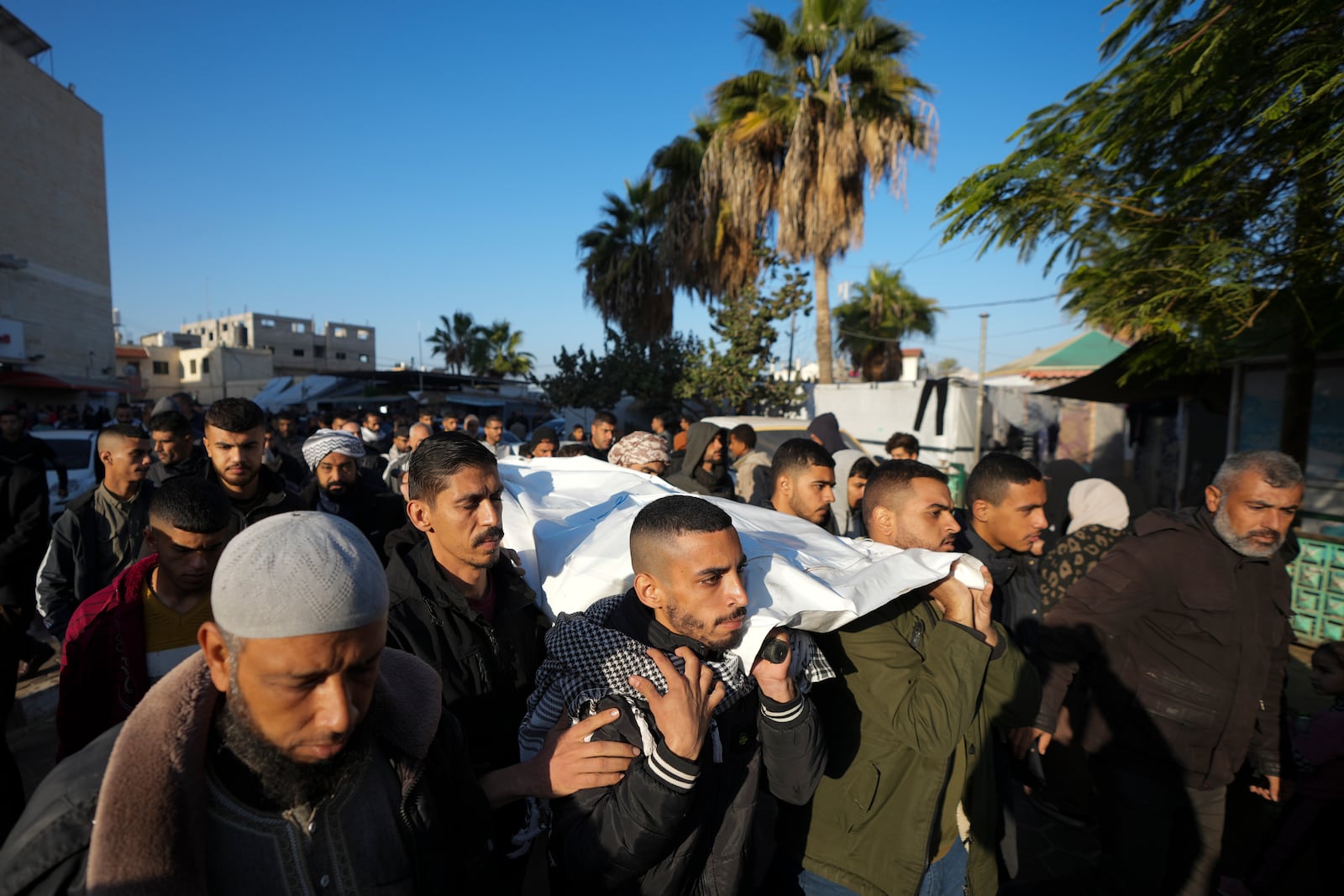 Palestinians carry the body of victim of an overnight Israeli strike, during a funeral in Deir al-Balah, Gaza Strip, Wednesday, Dec. 4, 2024. (AP Photo/Abdel Kareem Hana)