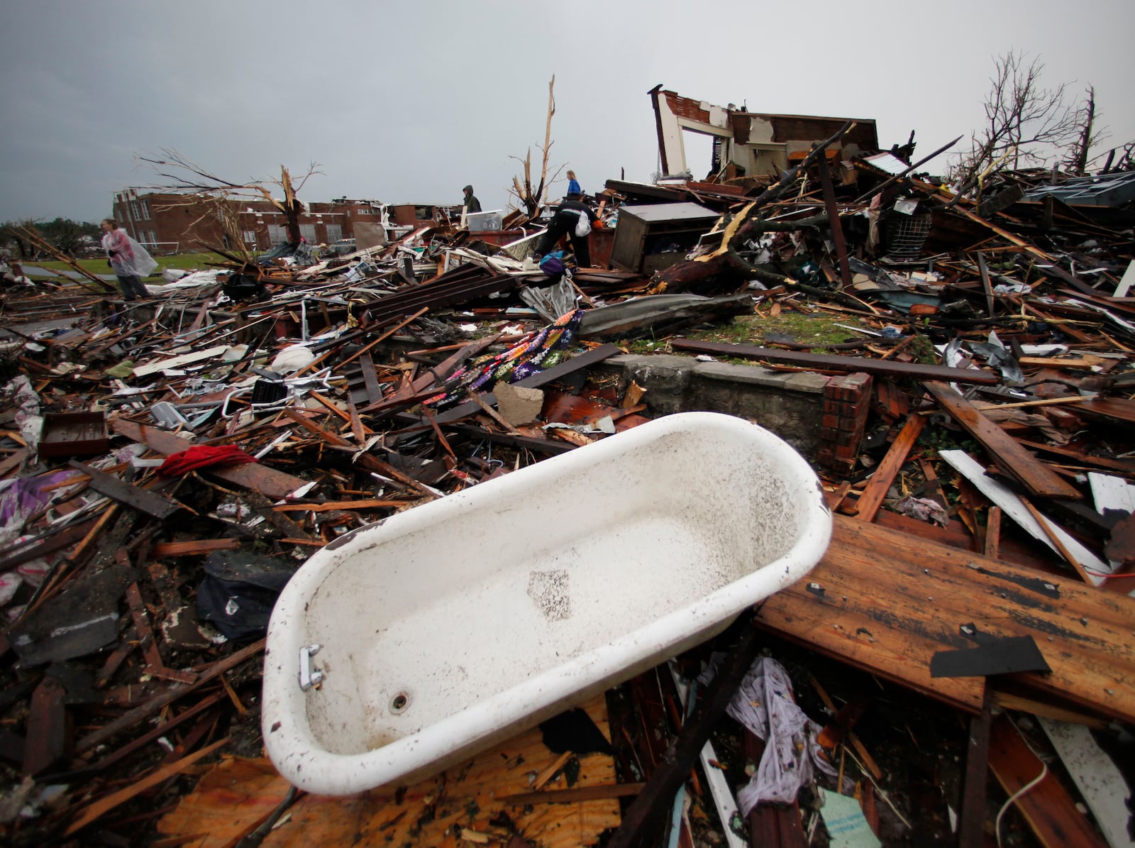 FILE- A bathtub lies among Tornado debris in Joplin, Mo., Monday, May 23, 2011. (AP Photo/Charlie Riedel, File)