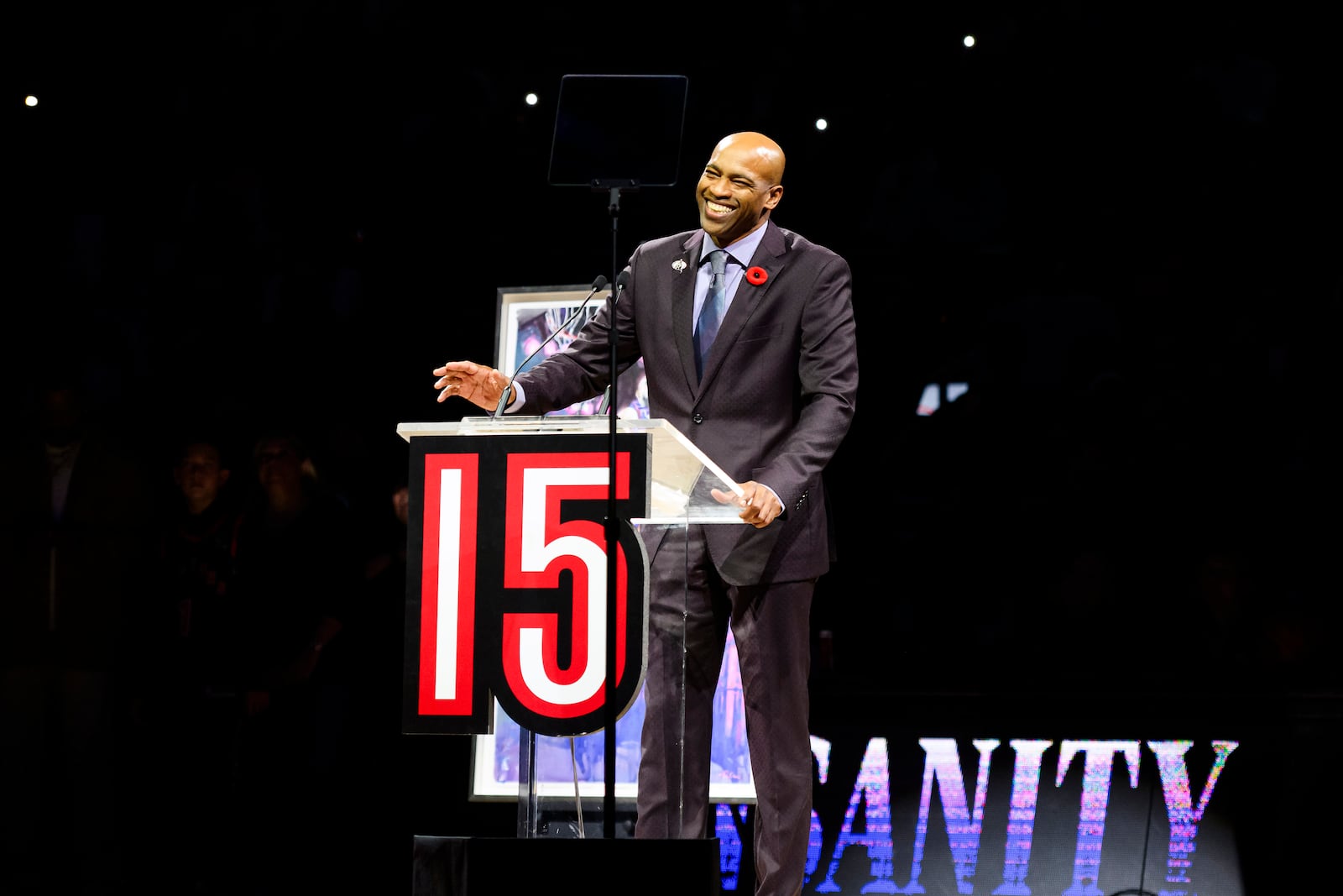 Former Toronto Raptors player Vince Carter reacts during his number retirement ceremony at halftime of an NBA basketball game between the Toronto Raptors and the Sacramento Kings in Toronto on Saturday, Nov. 2, 2024. (Christopher Katsarov/The Canadian Press via AP)