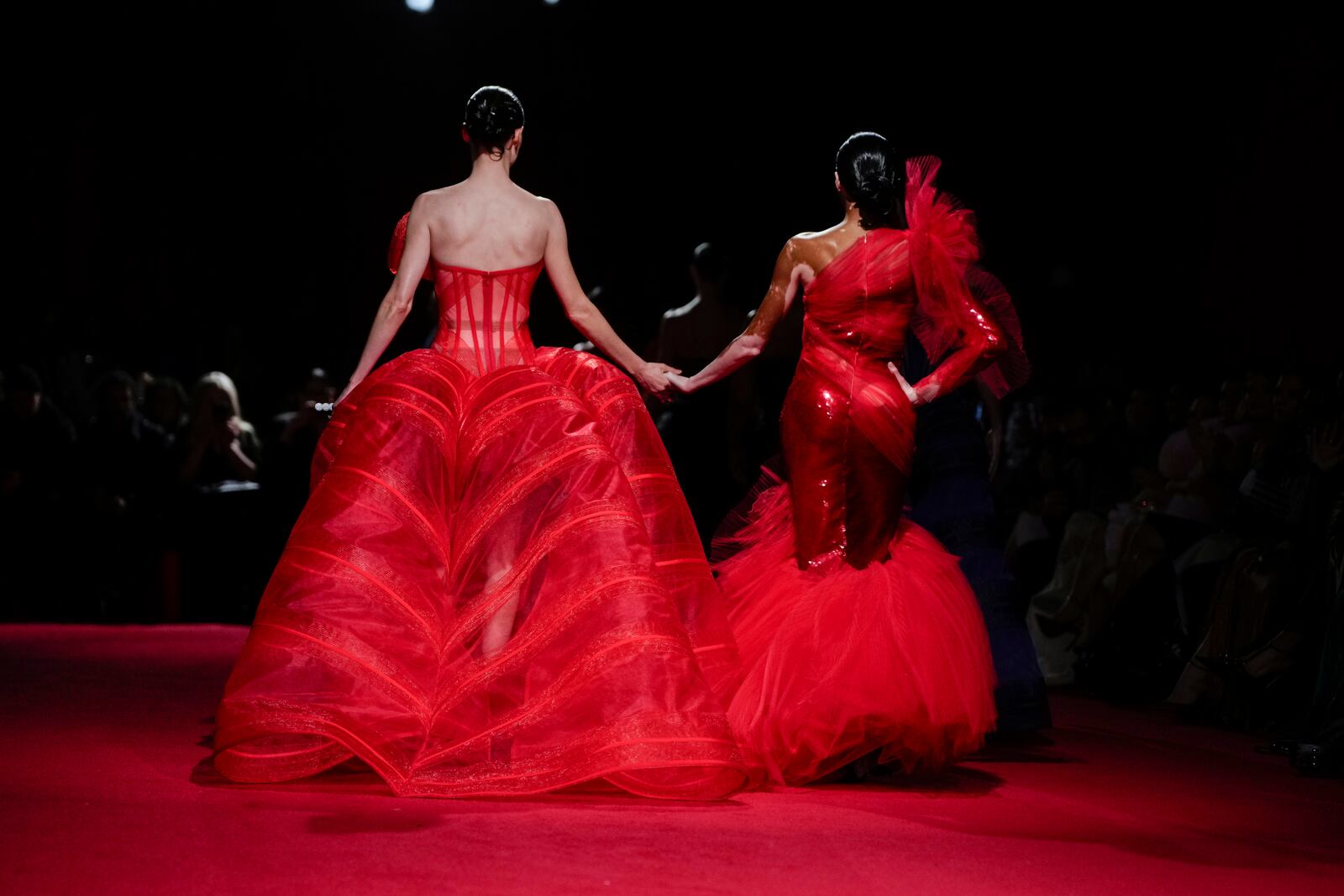 Coco Rocha, left, and Winnie Harlow walk the runway during the Christian Siriano Fall/Winter 2025 fashion show at Chelsea Industrial during New York Fashion Week on Thursday, Feb. 6, 2025, in New York. (Photo by Charles Sykes/Invision/AP)