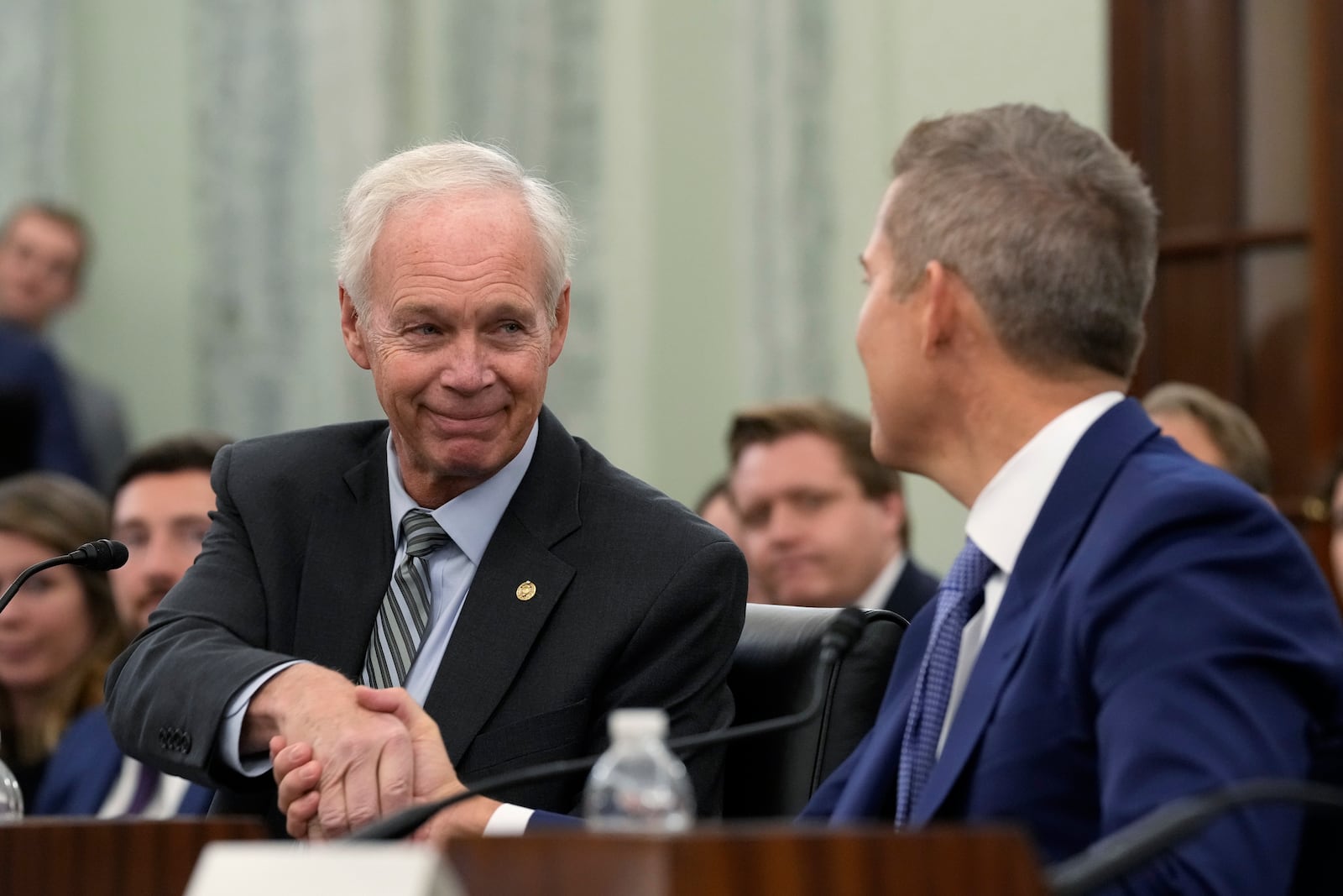 Sen. Ron Johnson, R-Wis., left, shakes hands with former Wisconsin Rep. Sean Duffy, R-Wis., right, before Duffy testifies before the Senate Commerce, Science, and Transportation Committee on Capitol Hill in Washington, Wednesday, Jan. 15, 2025, on his nomination to be Transportation Secretary. (AP Photo/Susan Walsh)